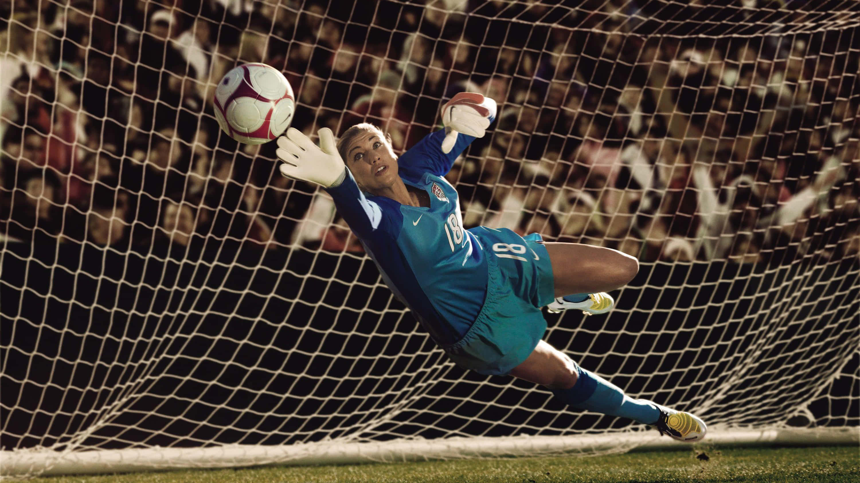 female soccer goalkeeper, teal uniform, dives dynamically, 2K Desktop Wallpaper