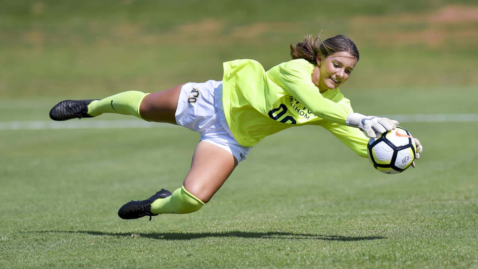 female soccer goalie, bright neon yellow, dynamically to catch, HD Desktop Wallpaper