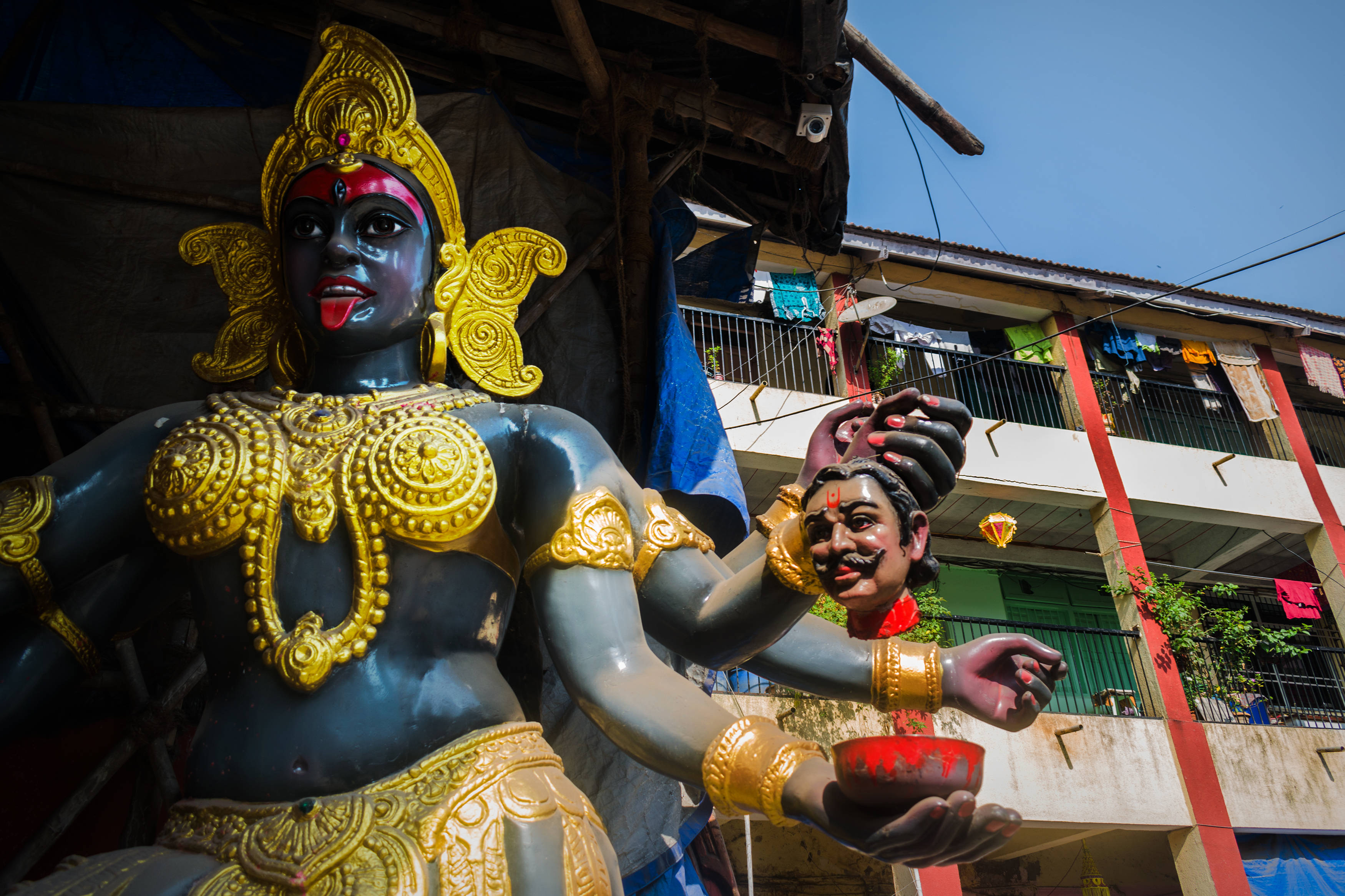 Goddess Kali, blue and gold statue, red face, 2K Desktop Wallpaper