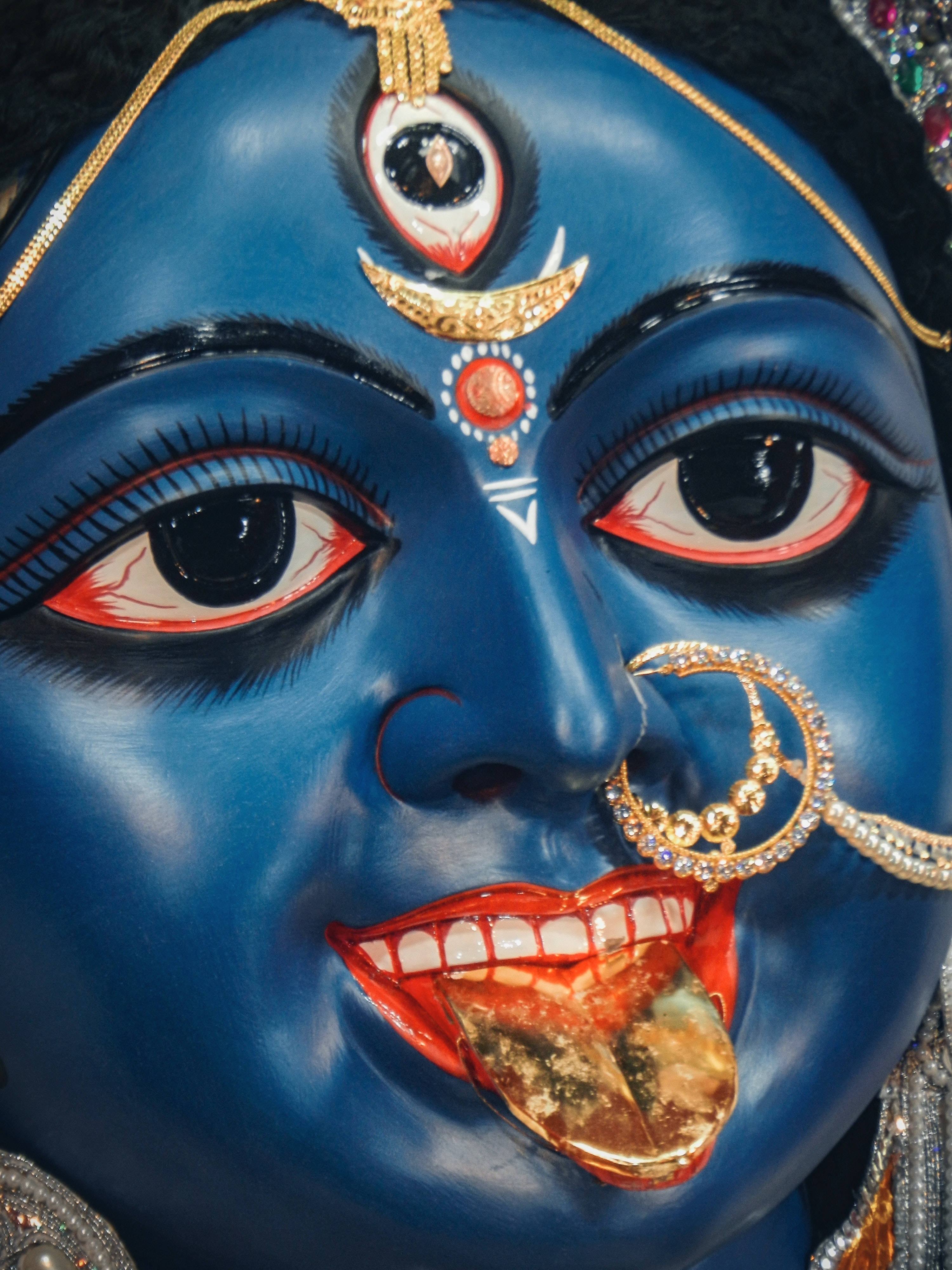 Goddess Kali, vivid blue deity statue, red eyes, 4K Phone Wallpaper