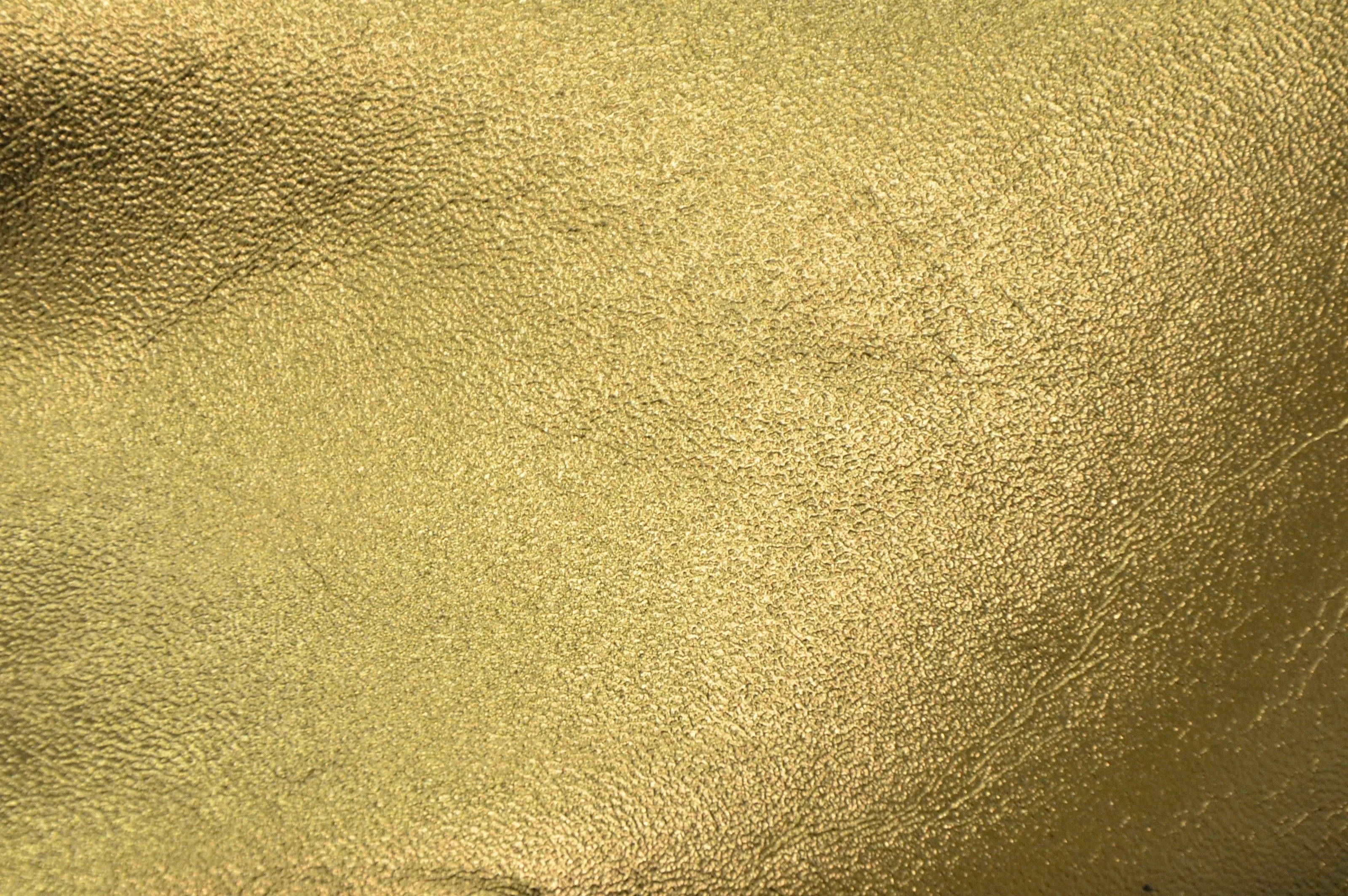 matte gold foil, textured golden metallic surface, subtle highlights, 2K Desktop Wallpaper