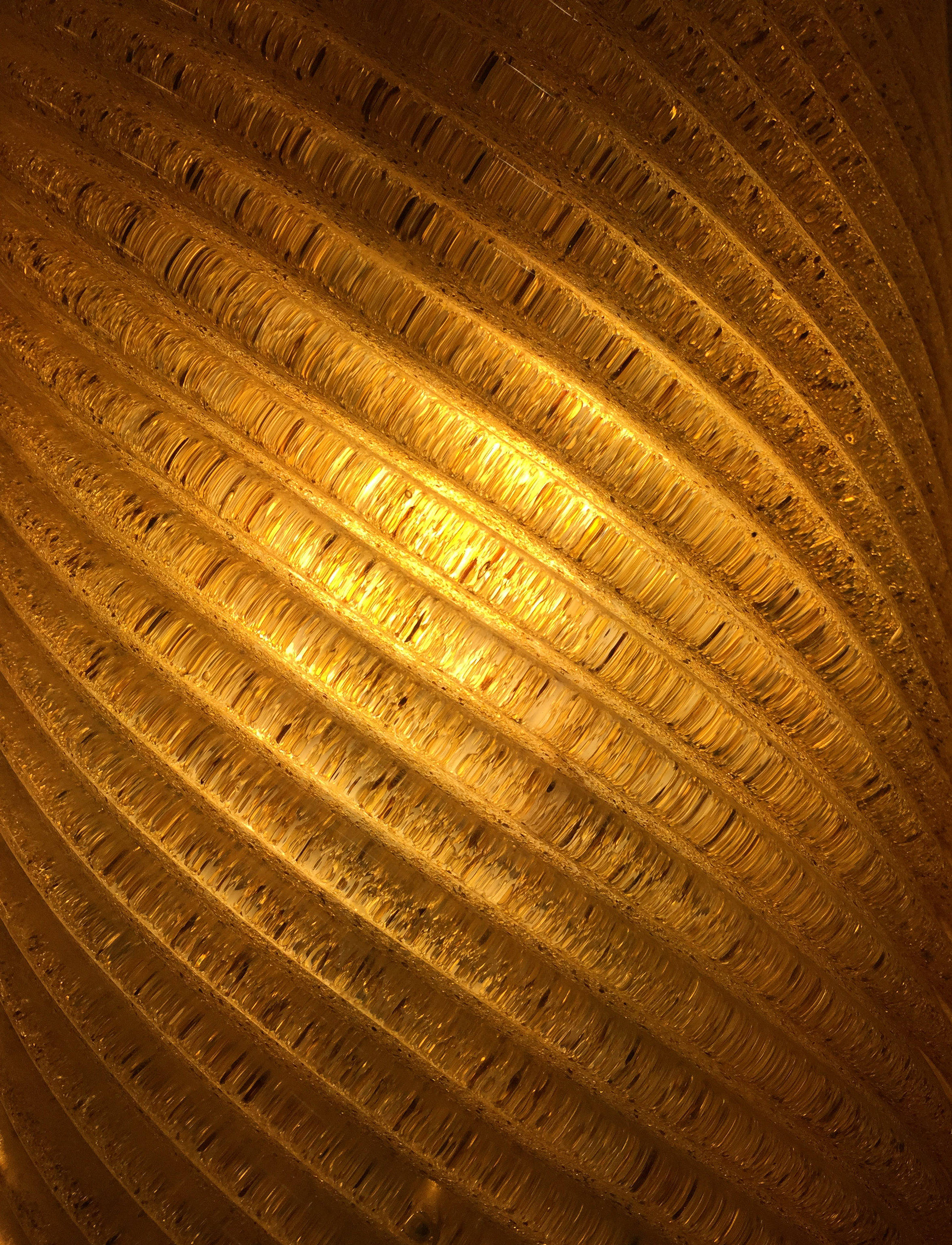 gold spiral, warm golden light, textured ribbed glass, 2K Phone Wallpaper