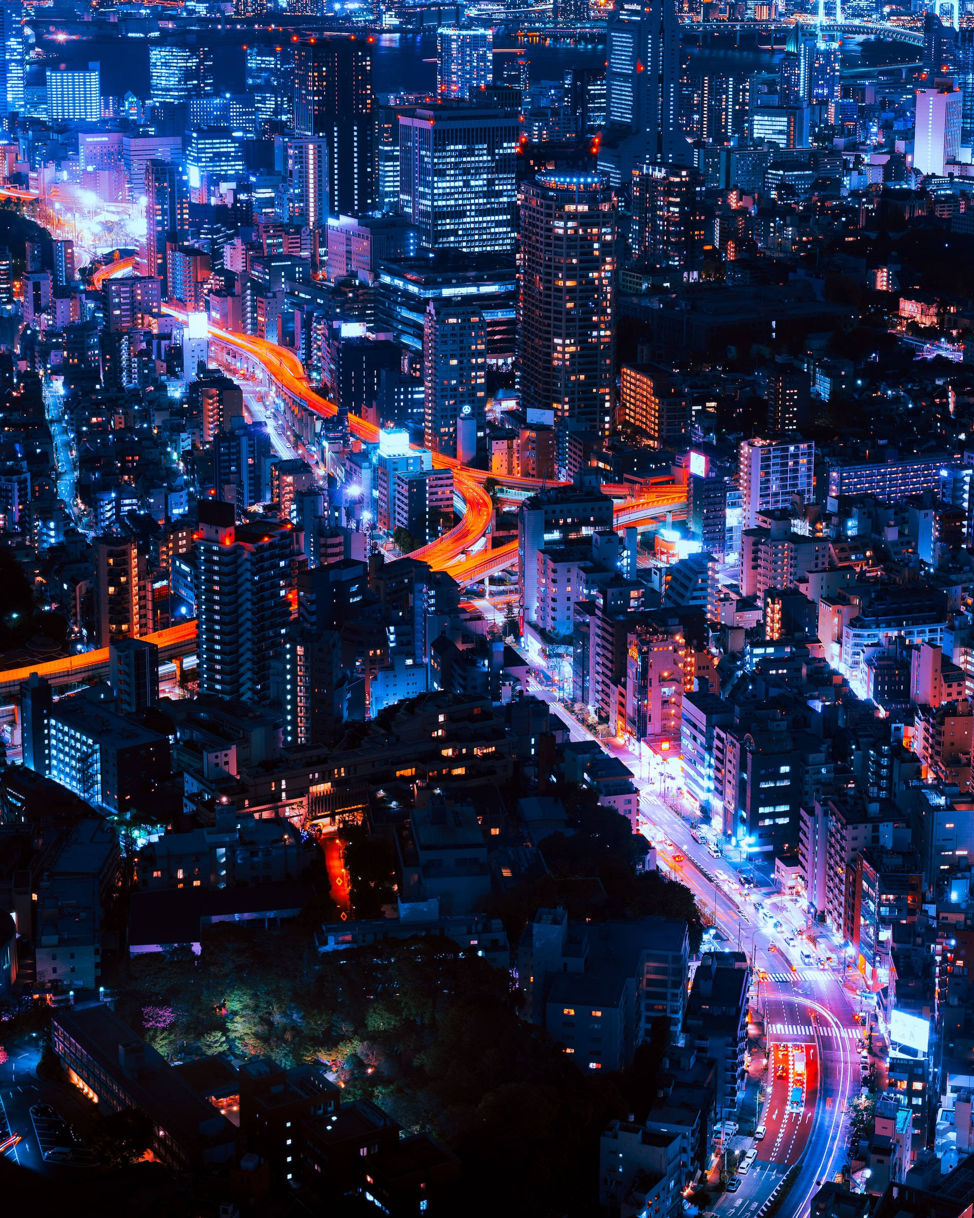 neon-lit cityscape, glowing blue and orange lights, traffic trails, Full HD Phone Wallpaper