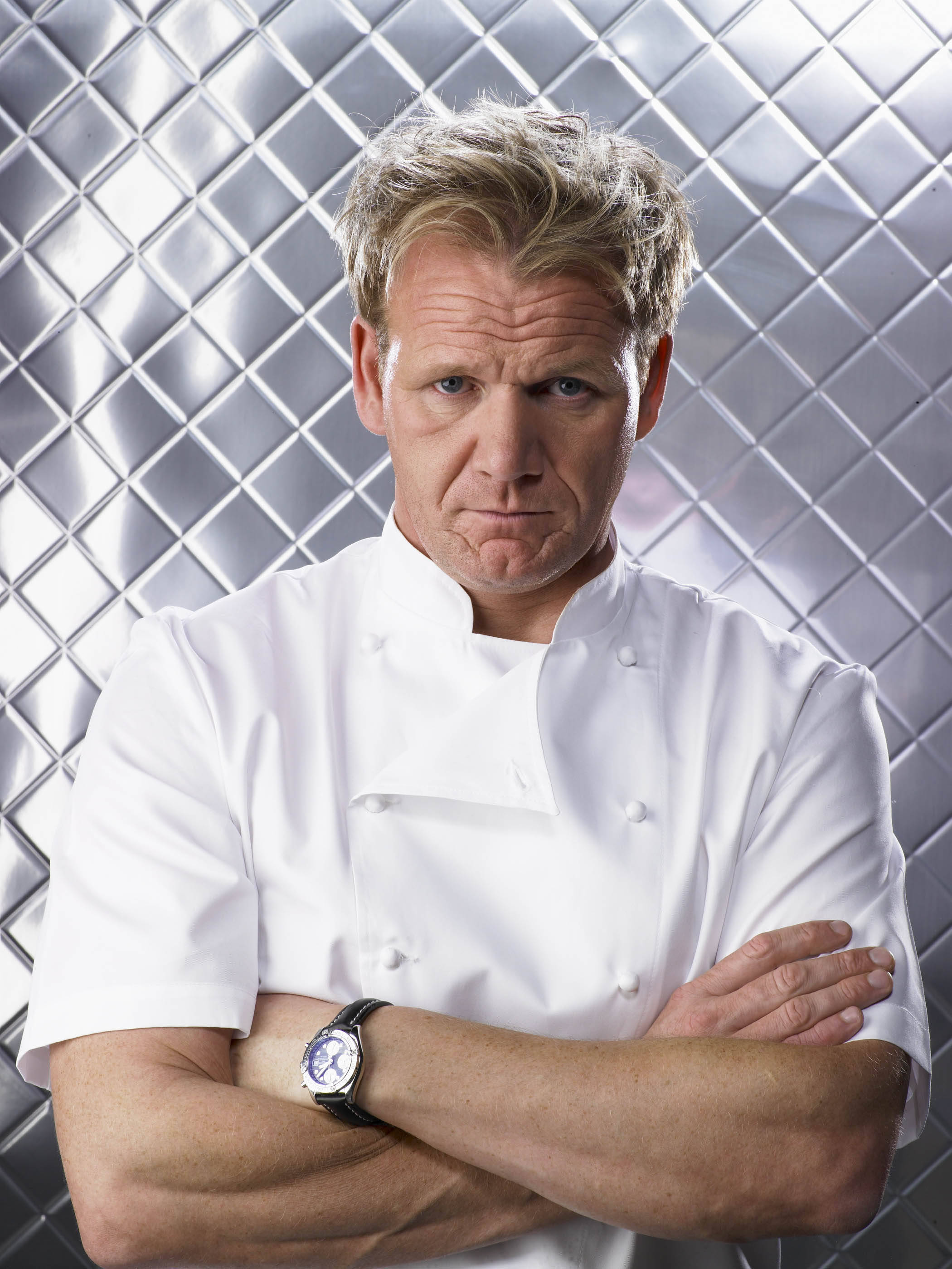 Gordon Ramsay, white chef's coat, metallic diamond-patterned wall, 2K Phone Wallpaper