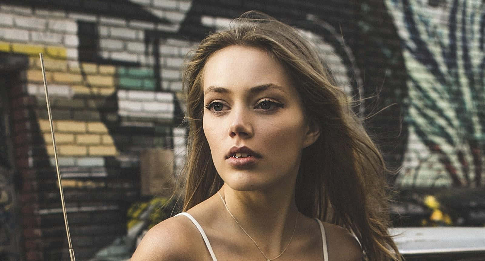 Grace Van Dien, long brown hair, graffiti-covered brick wall, HD Desktop Wallpaper