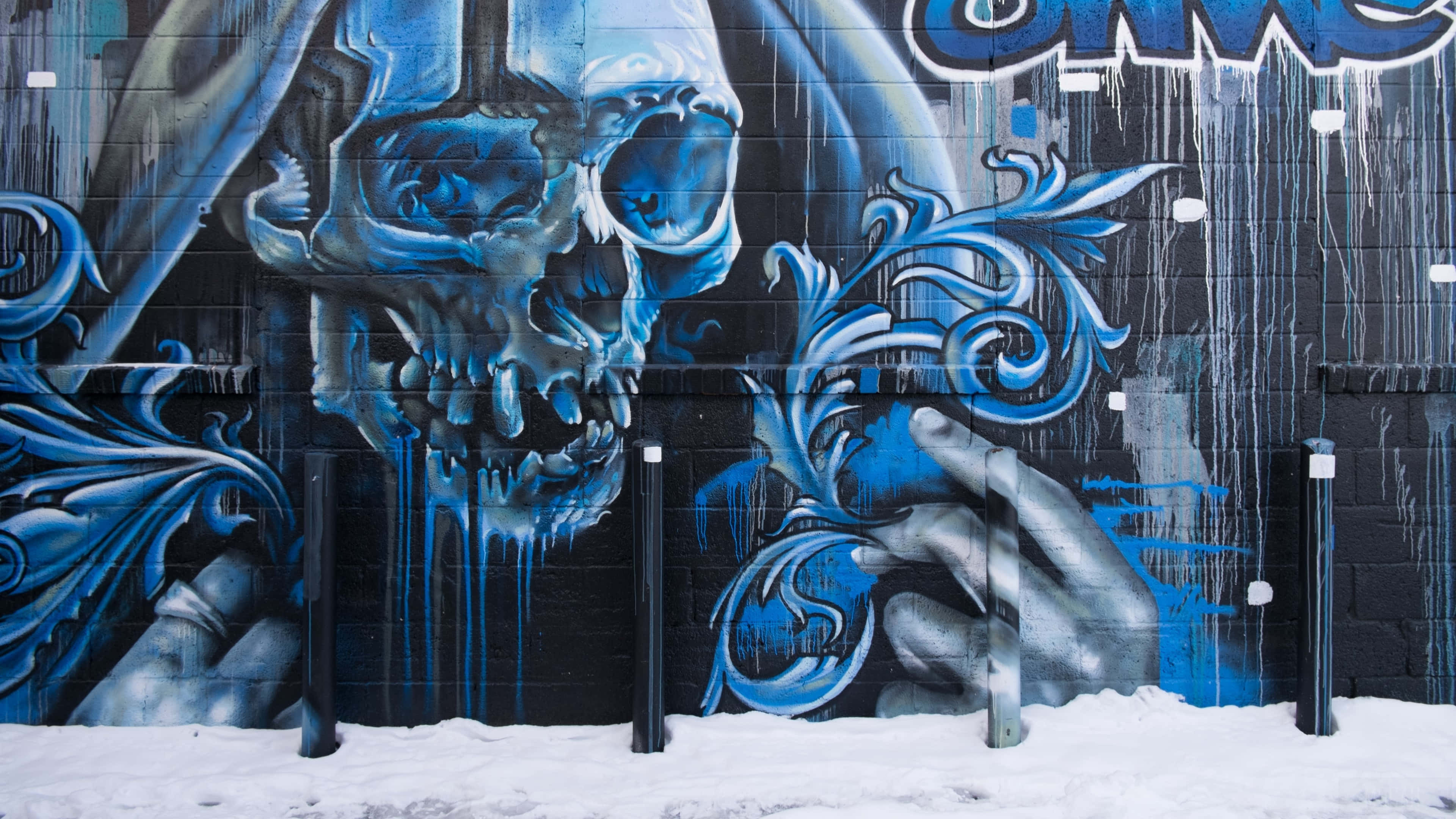 blue skull mural, ornate swirls, black brick wall, 4K Desktop Wallpaper