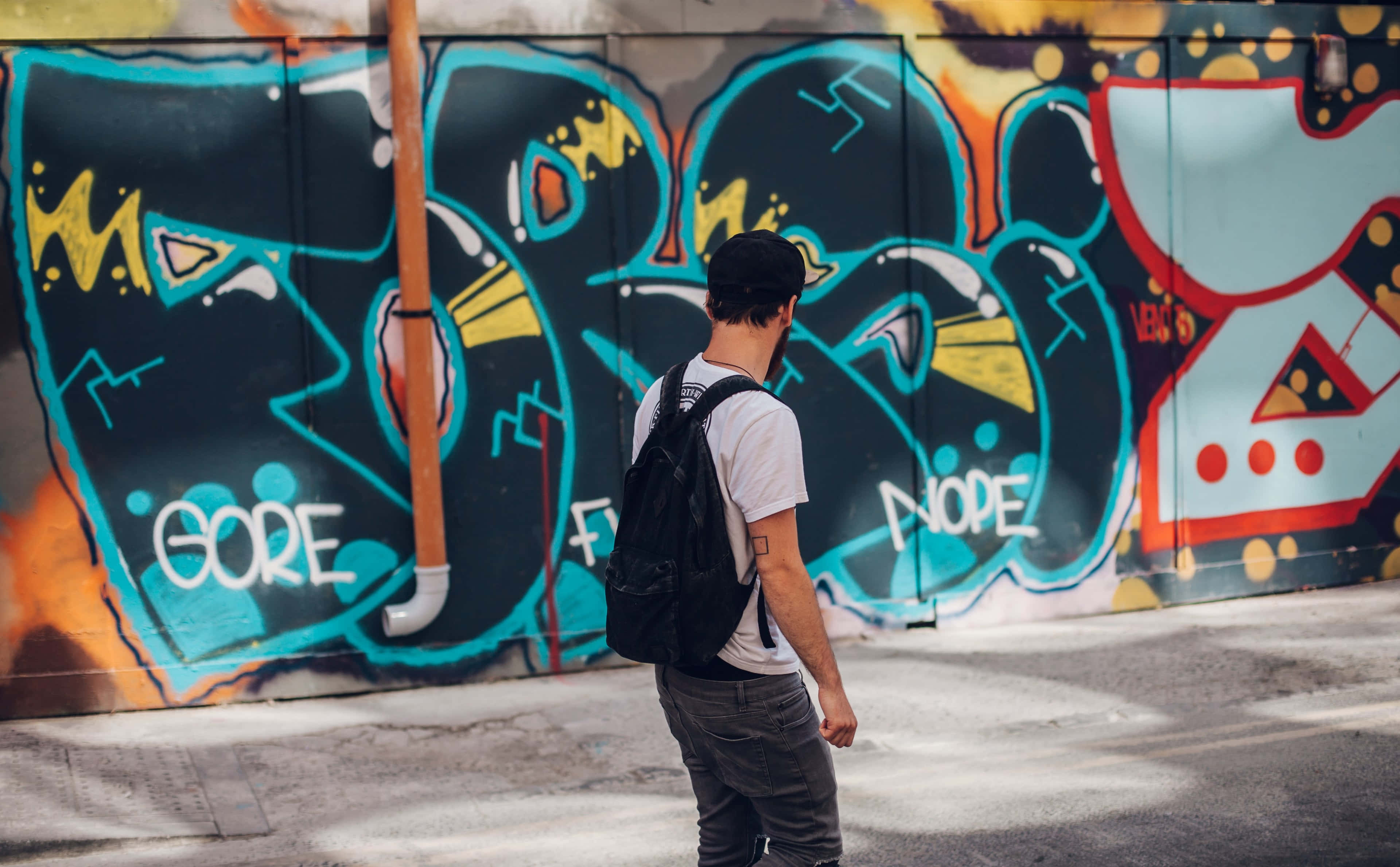 Graffiti 4K, vibrant graffiti-covered wall, bold blue yellow and orange tags, 4K Desktop Wallpaper