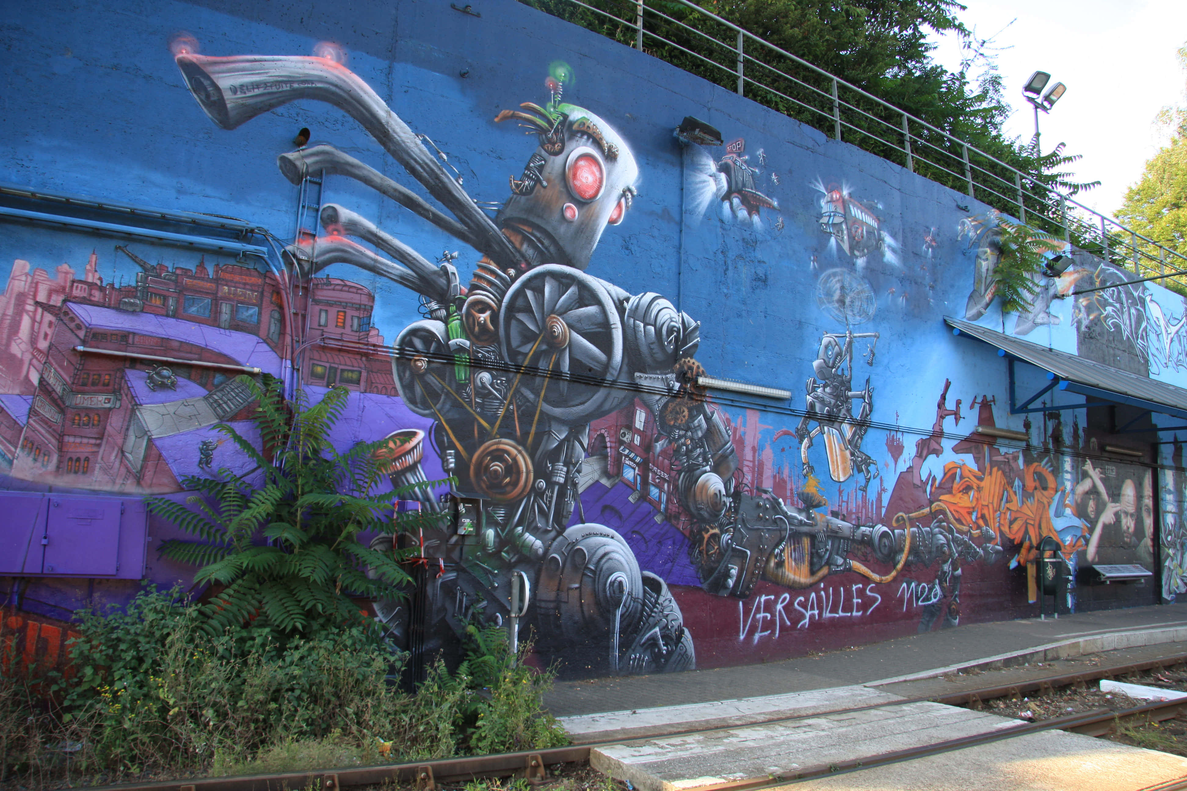 robotic graffiti mural, blue wall, train tracks, 4K Desktop Wallpaper