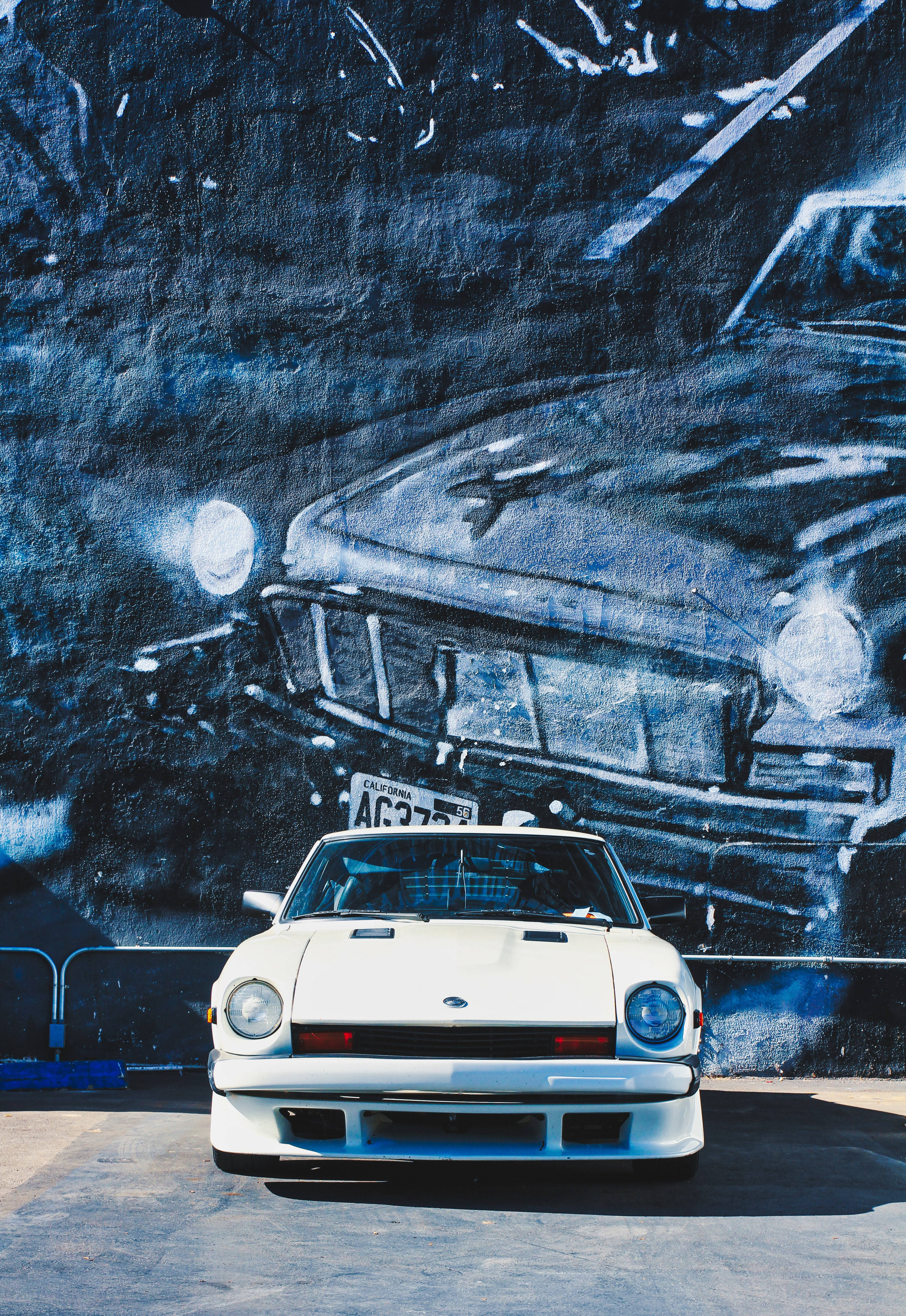 white classic car, blue and black graffiti mural, vintage car, 4K Phone Wallpaper