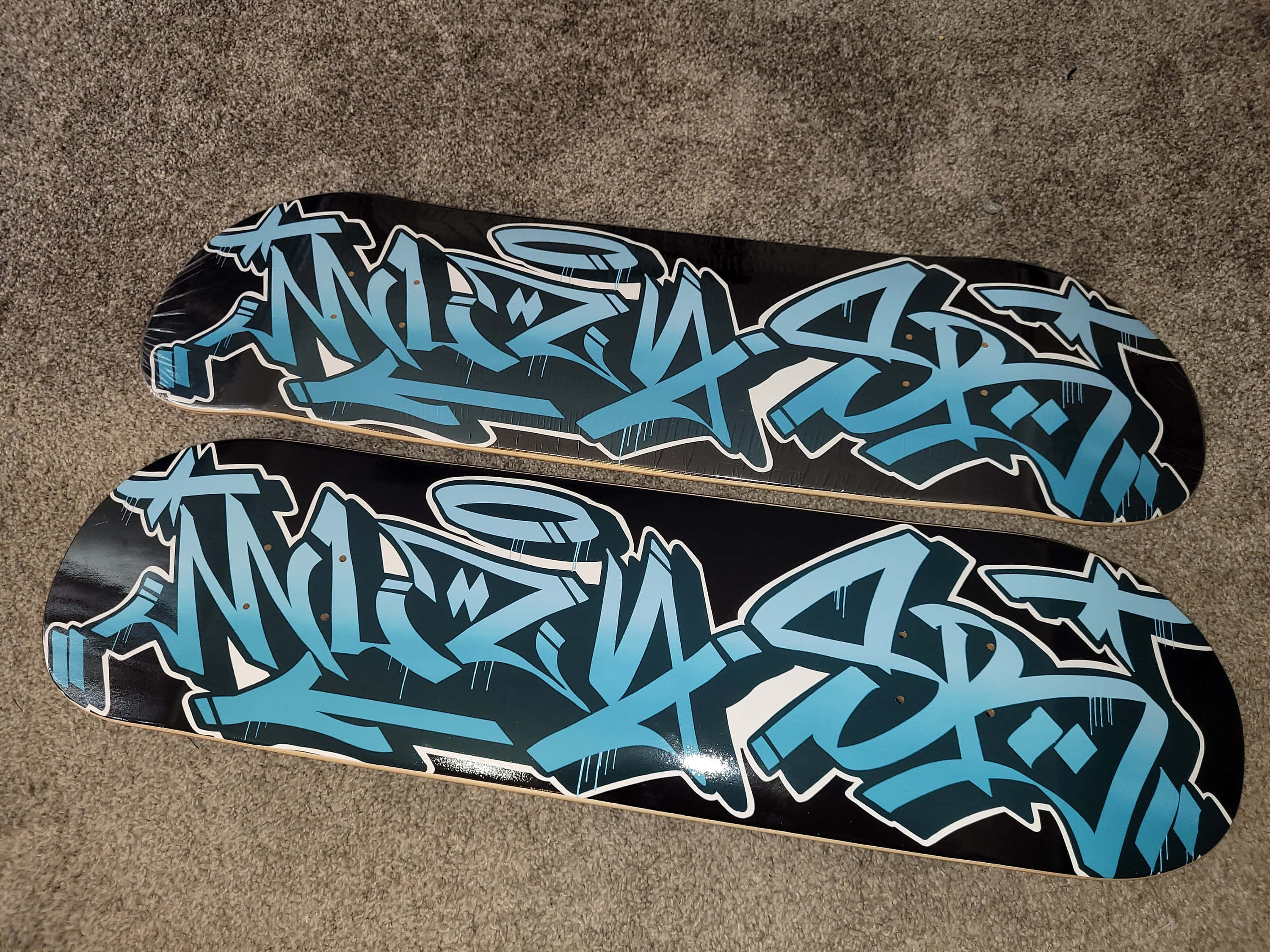 black skateboard decks, bold blue graffiti art, gray carpet, 2K Desktop Wallpaper