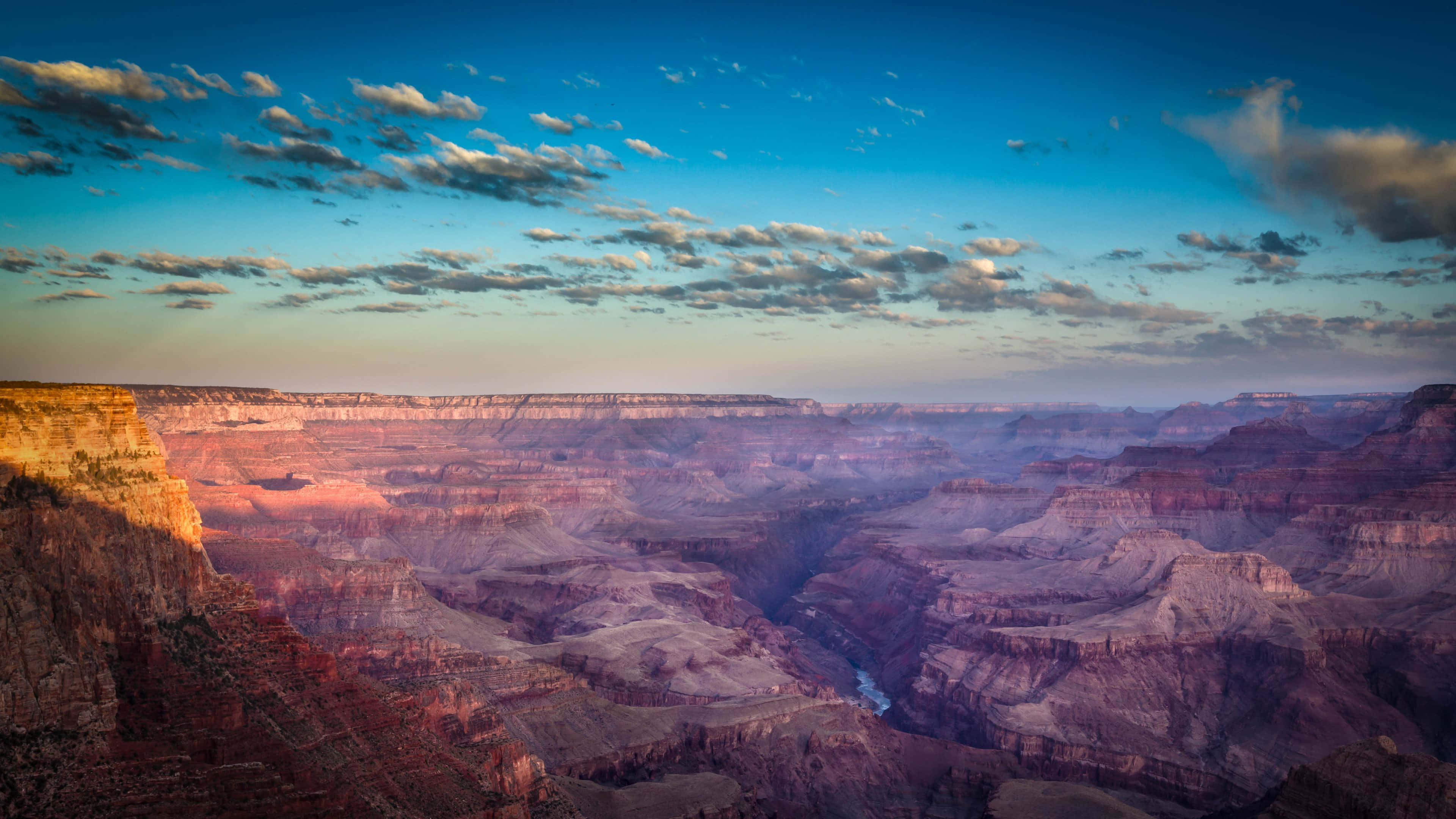 Grand Canyon, golden sunrise light, red rock formations, 4K Desktop Wallpaper
