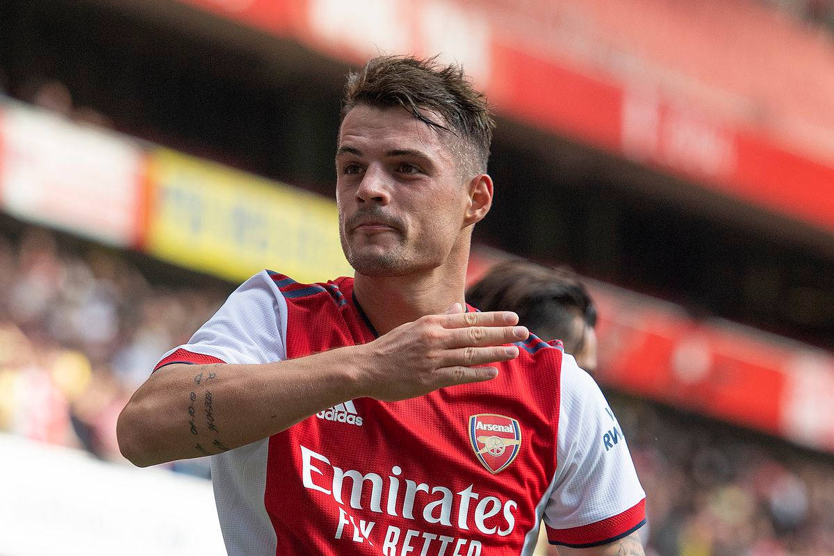 Granit Xhaka, red Arsenal jersey, sunlit stadium, SD Desktop Wallpaper