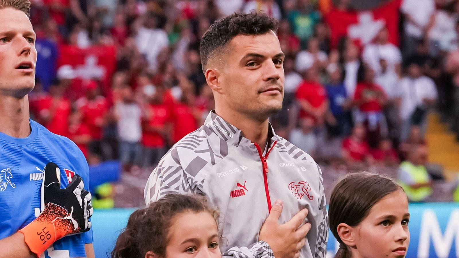 Granit Xhaka, gray jacket, hand over heart, HD Desktop Wallpaper