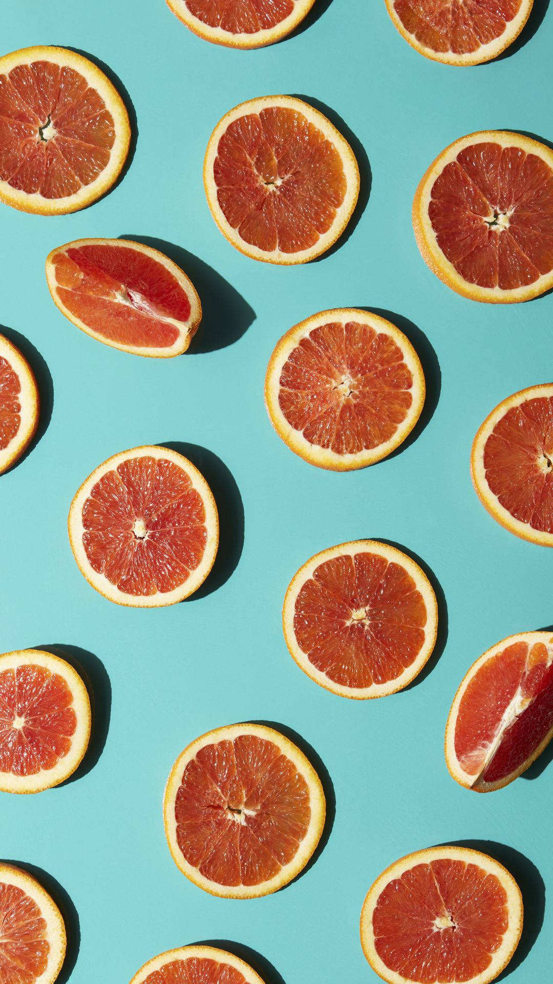 thinly sliced tropical citrus grapefruits, vibrant pattern, bright turquoise background, Full HD Phone Wallpaper
