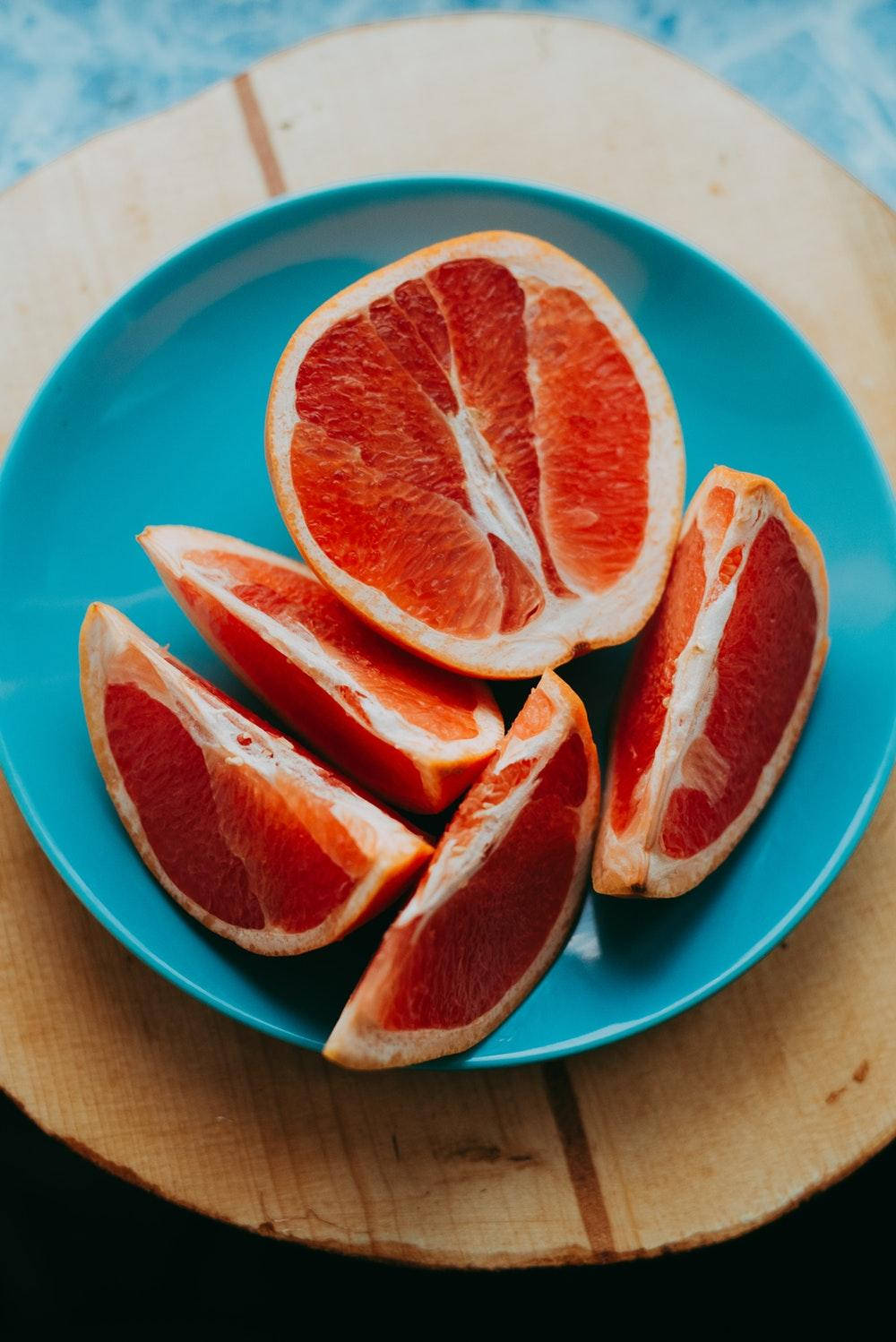 grapefruit slices, bright blue plate, rustic wooden board, HD Phone Wallpaper