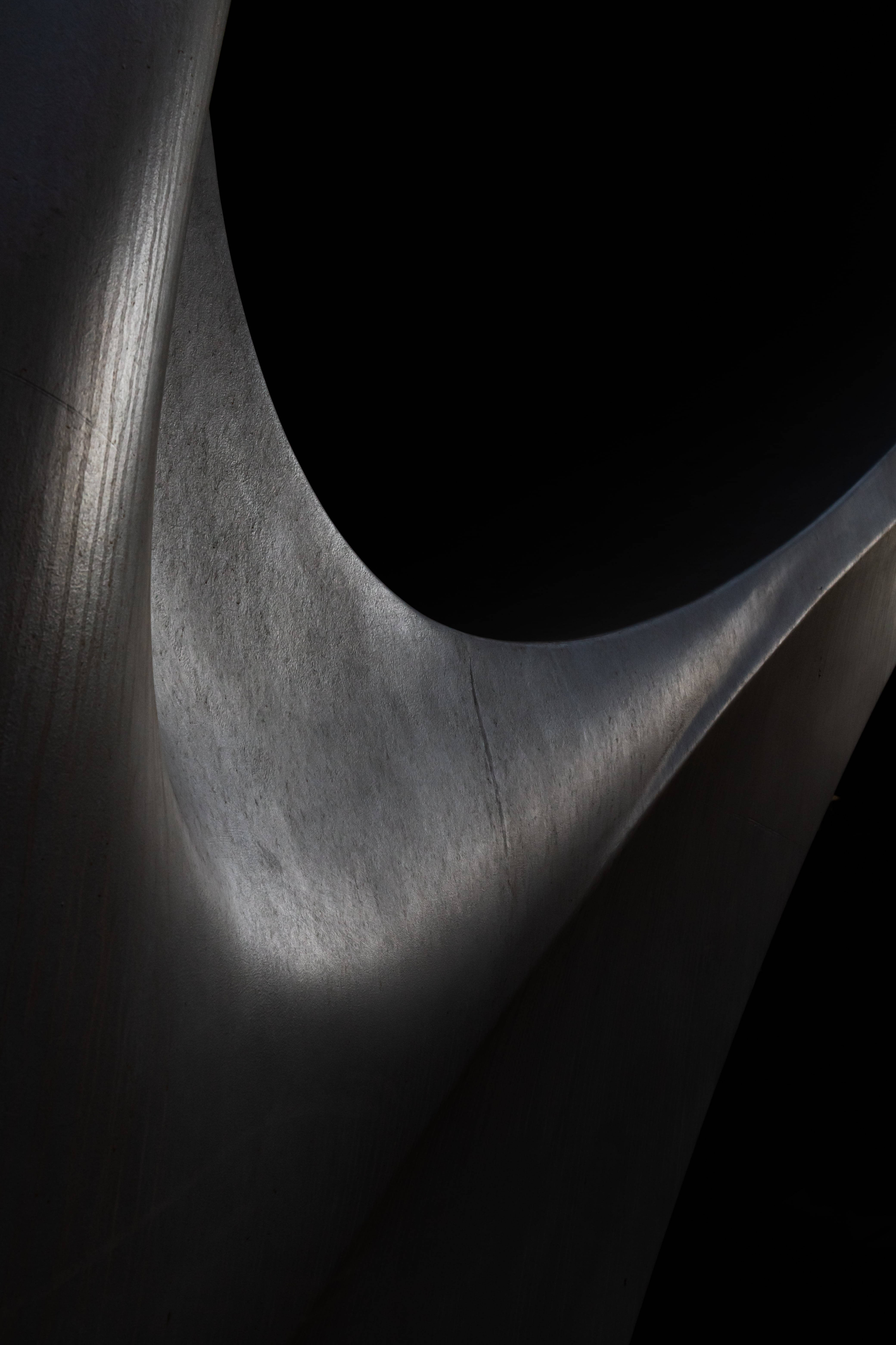 abstract black sculpture, dimly lit room, sleek metallic sculpture, 5K Phone Wallpaper
