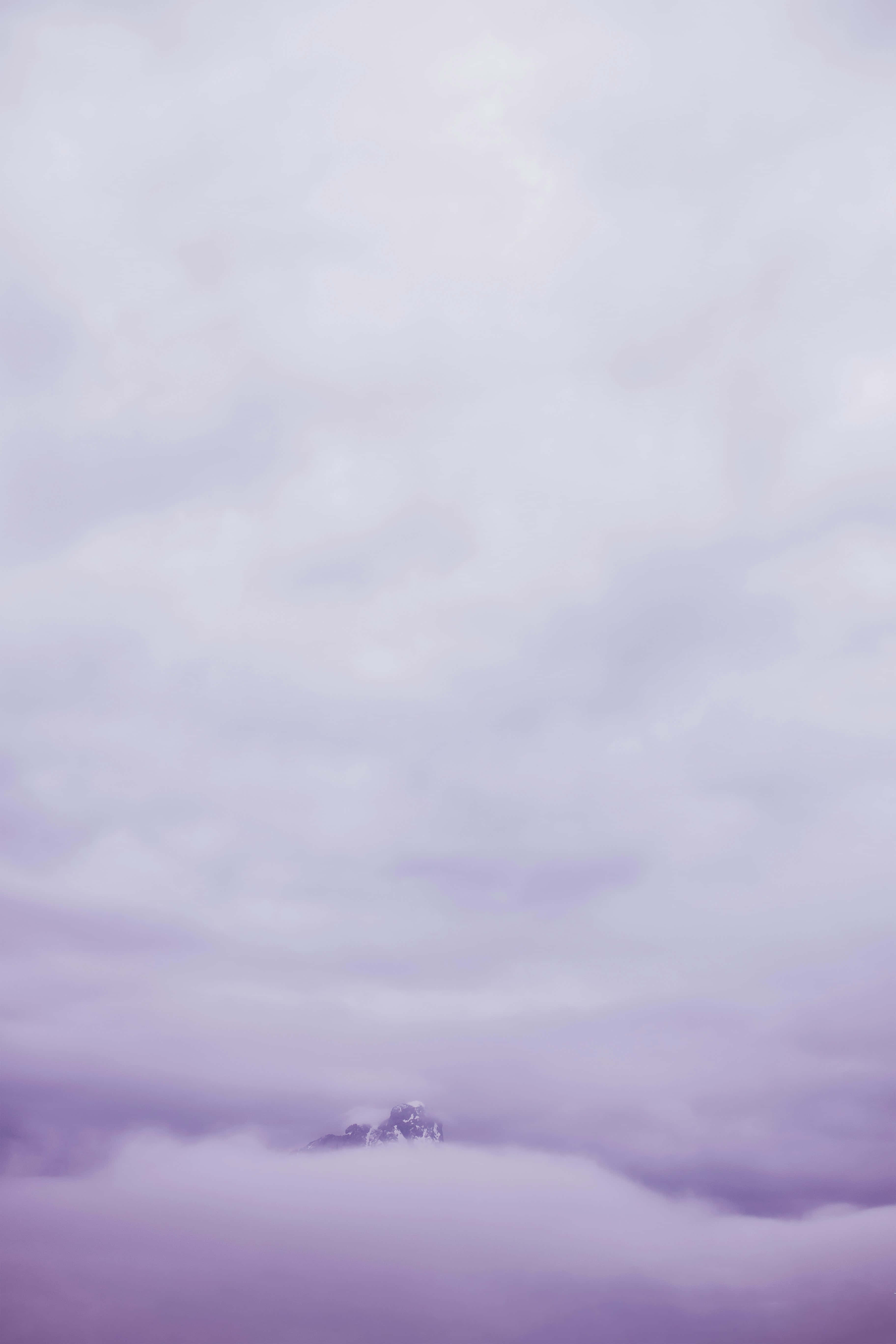 serene lavender mountain peak, snow-capped mountain peak, sea of soft lavender clouds, 5K Phone Wallpaper