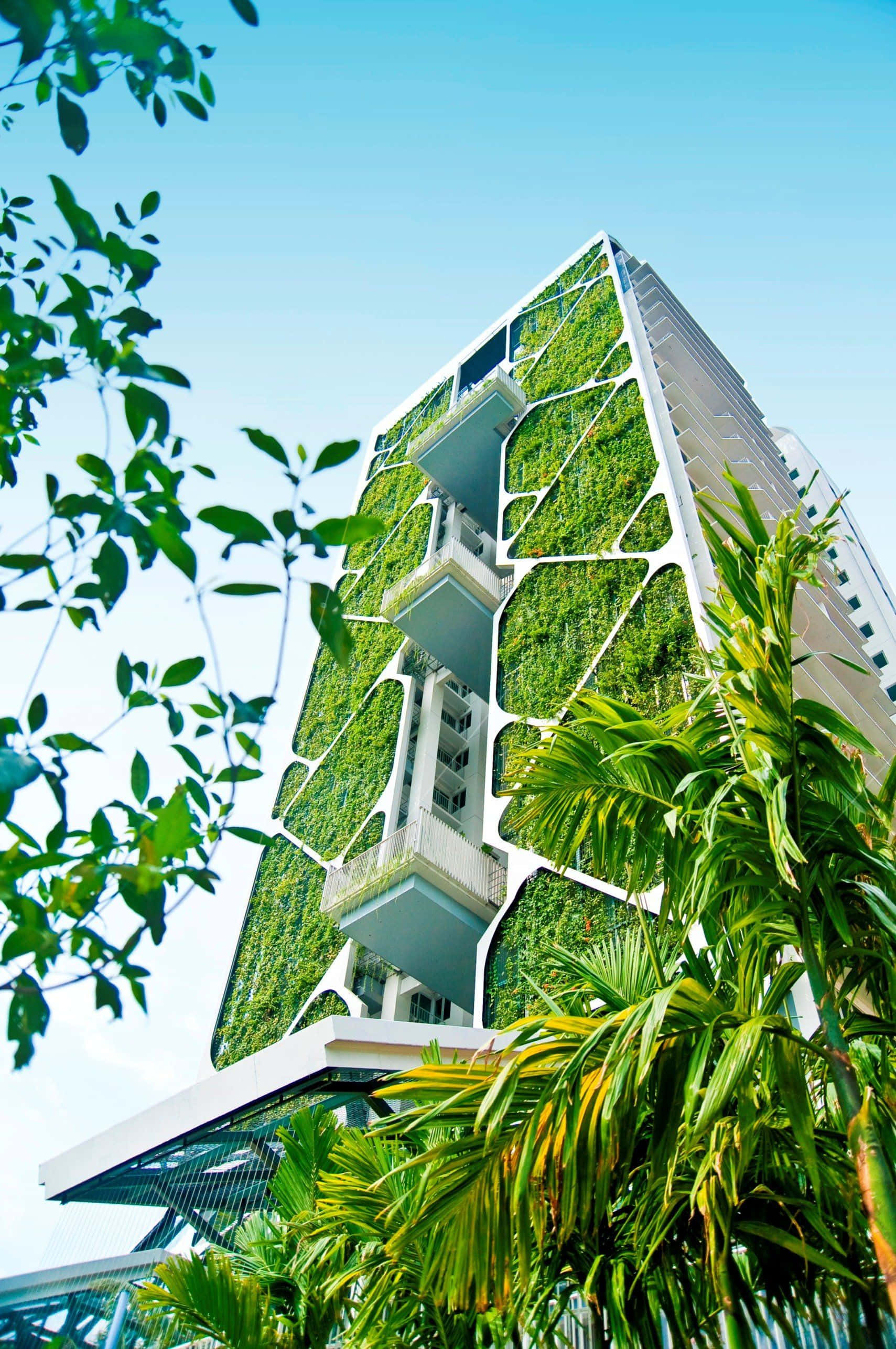modern skyscraper, lush greenery, clear blue sky, 2K Phone Wallpaper