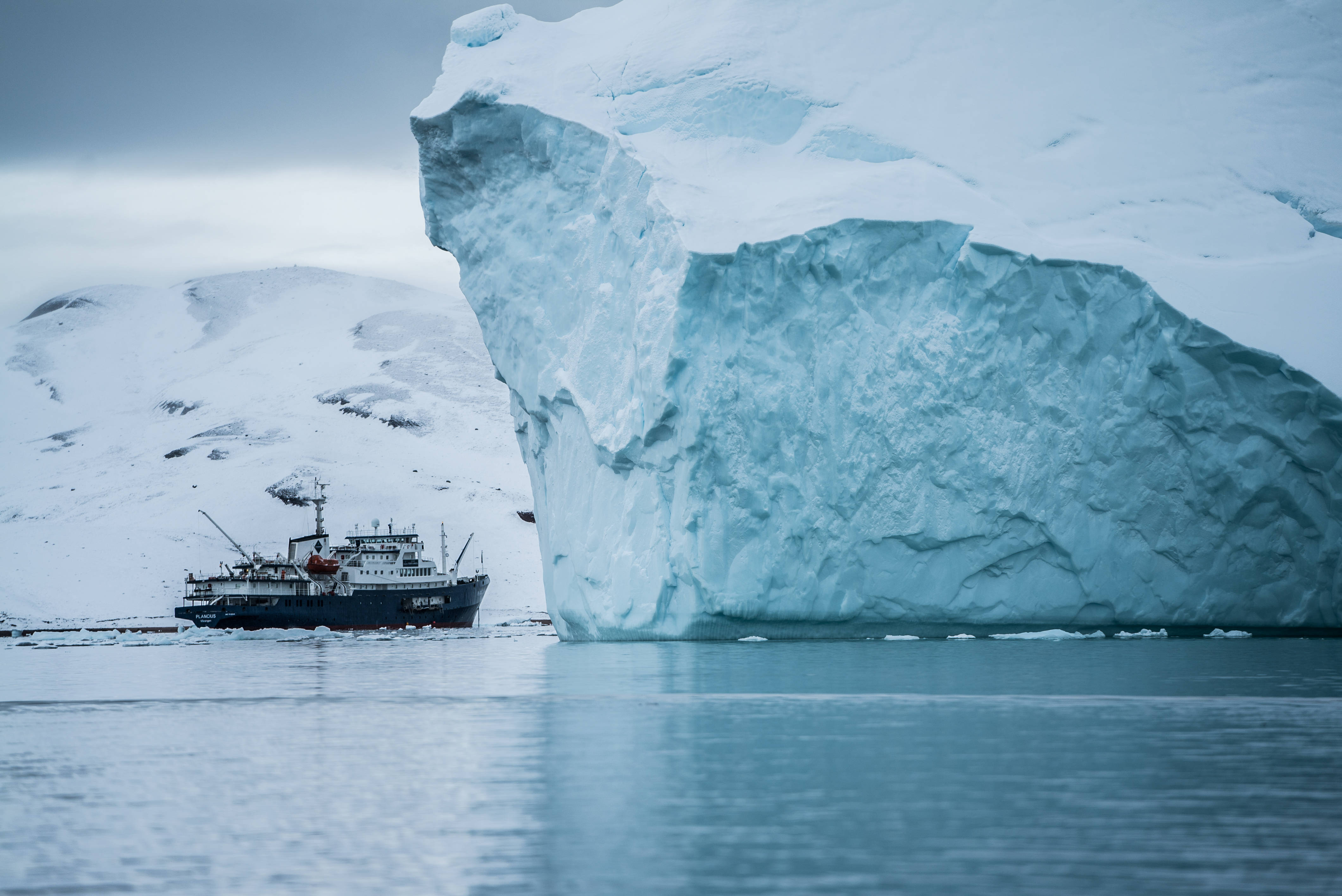 research vessel, massive translucent blue iceberg, calm waters, 4K Desktop Wallpaper