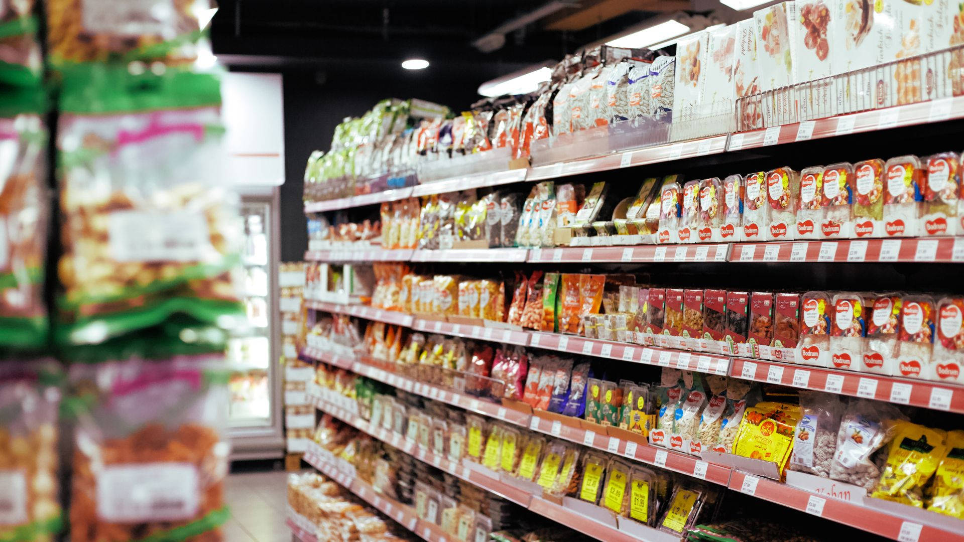 grocery store aisle, colorful snack packages, neatly stocked shelves, Full HD Desktop Wallpaper