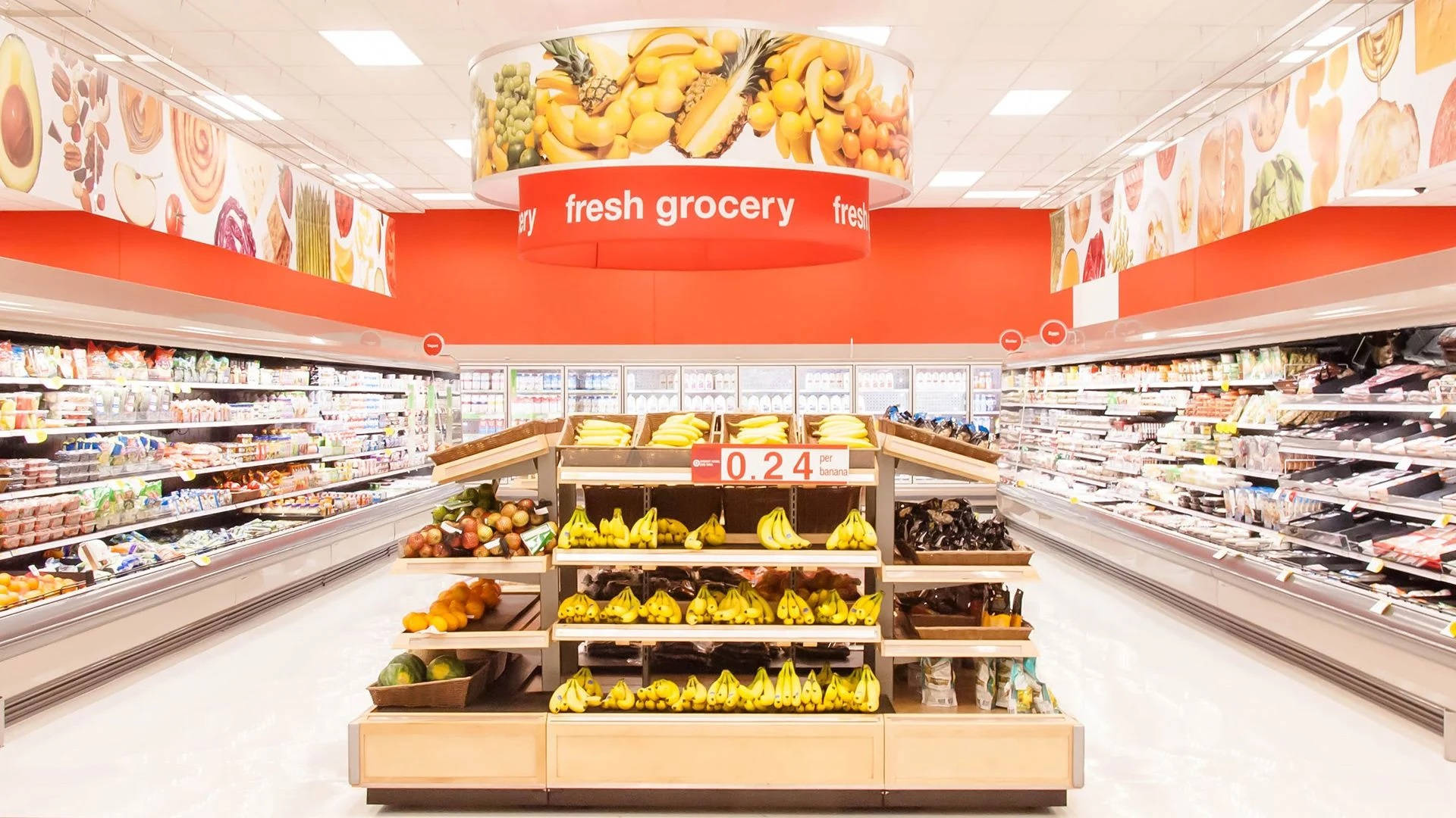 fresh produce displays, brightly lit grocery store aisle, bold red signage overhead, Full HD Desktop Wallpaper