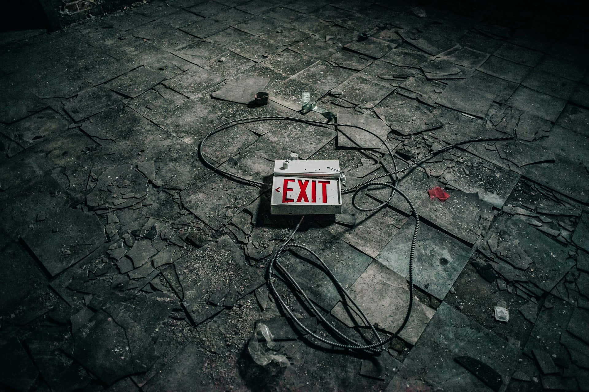 abandoned exit sign, cracked and shattered tiled floor, dimly lit ruin, Full HD Desktop Wallpaper