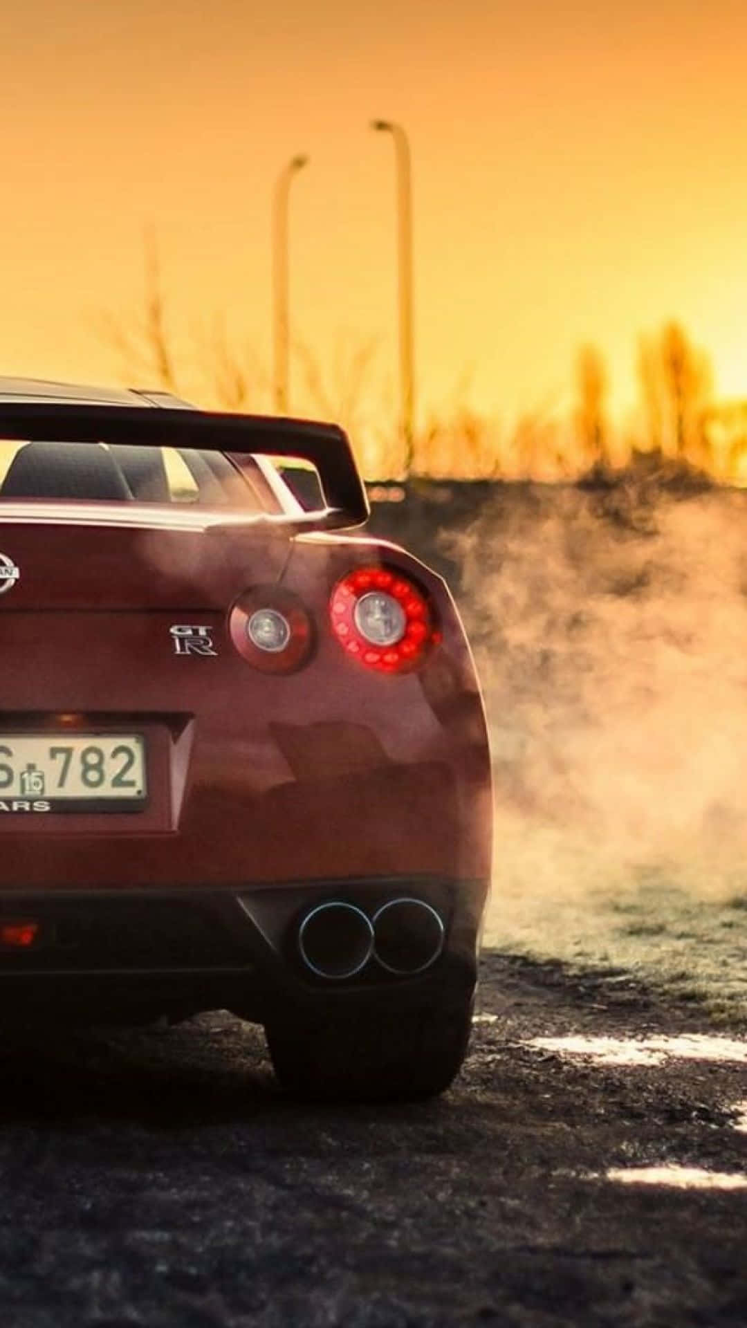maroon Nissan GT-R, sunset, dusty road, Full HD Phone Wallpaper