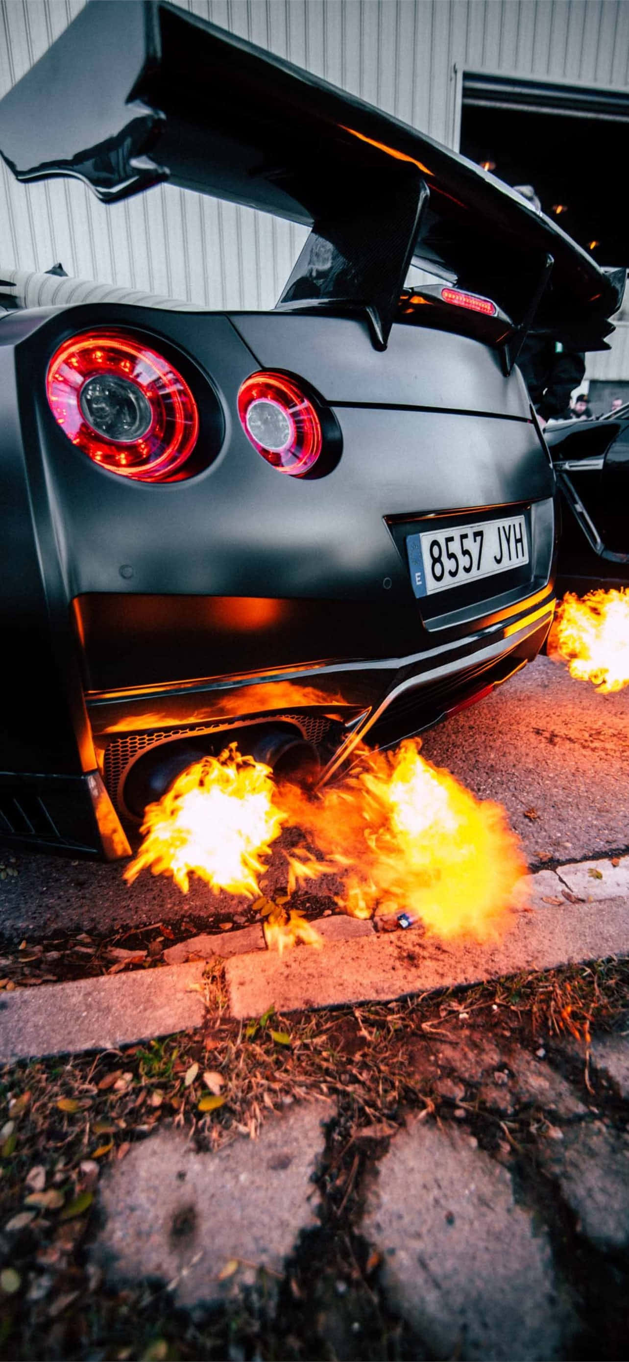 GTR, matte black, glowing red taillights, 2K Phone Wallpaper
