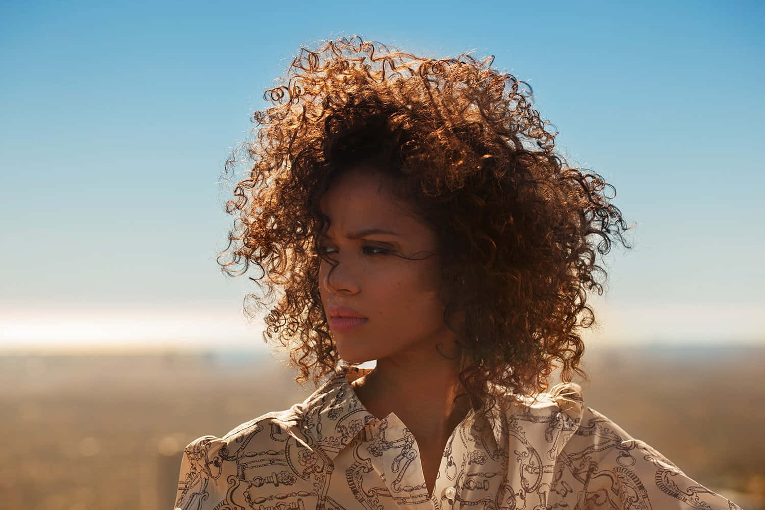 Gugu Mbatha-Raw, voluminous curly hair, clear blue sky, HD Desktop Wallpaper