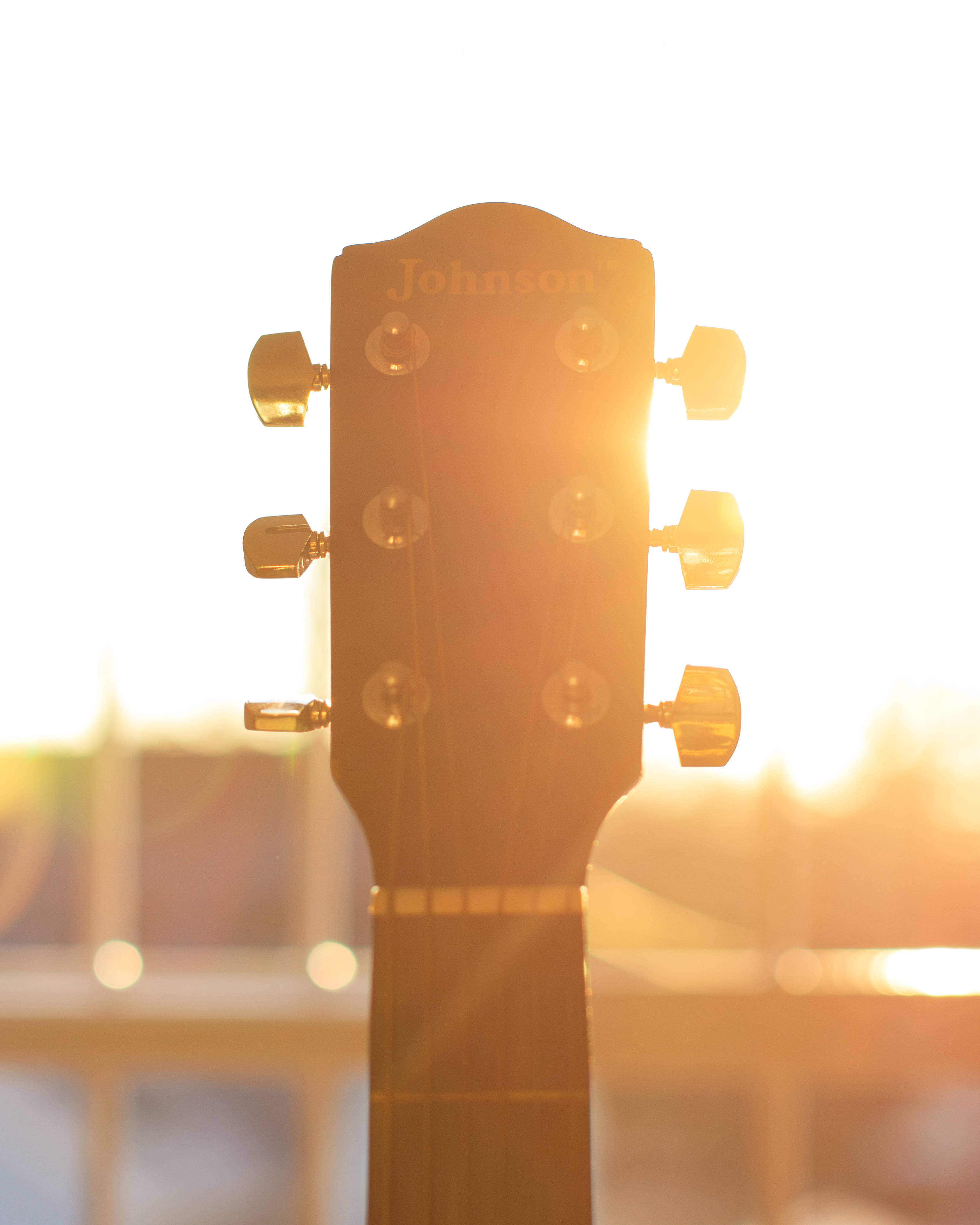 guitar headstock, warm golden sunset, lens flare, 4K Phone Wallpaper