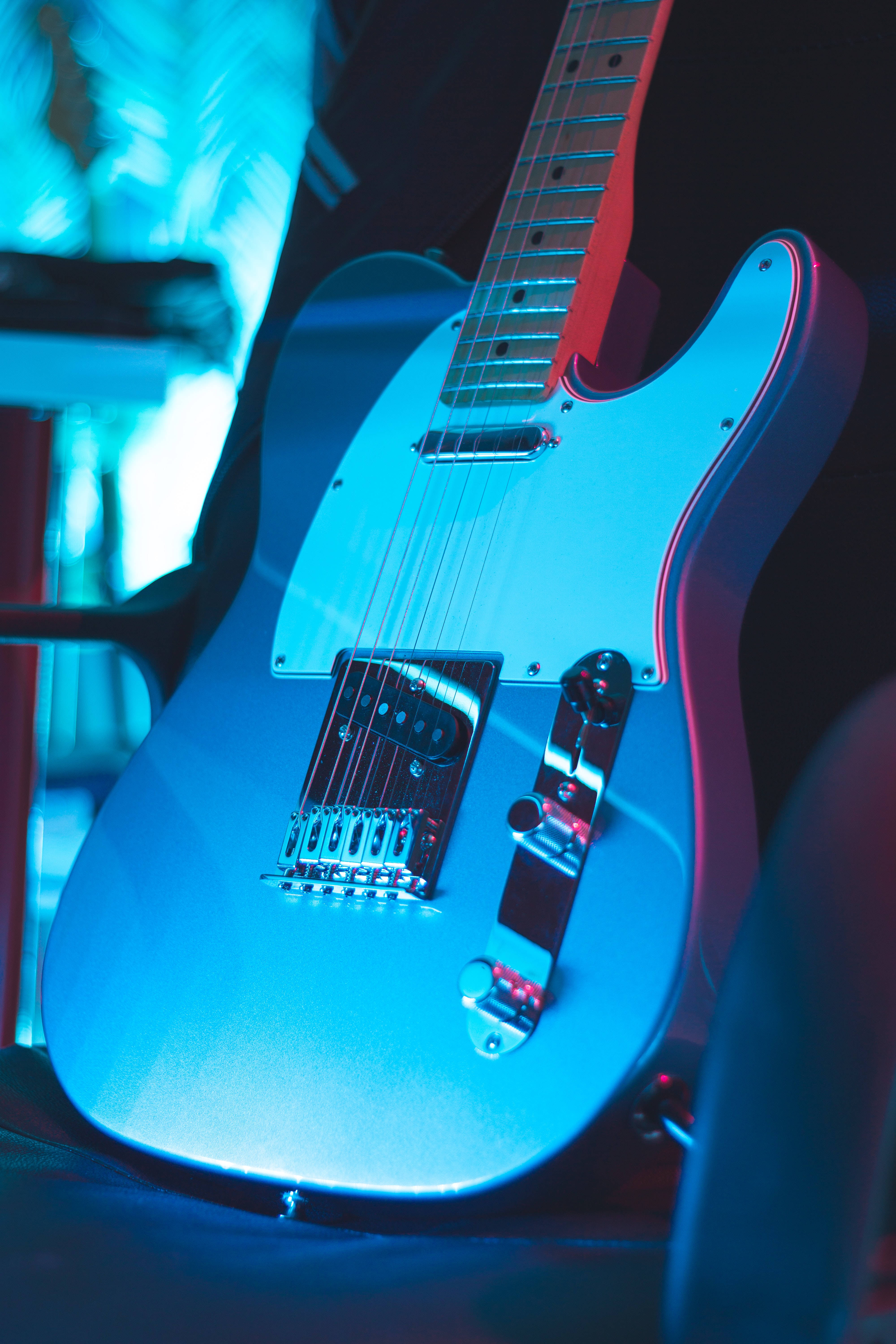 neon light electric guitar, sleek blue, vibrant stage lights, 5K Phone Wallpaper