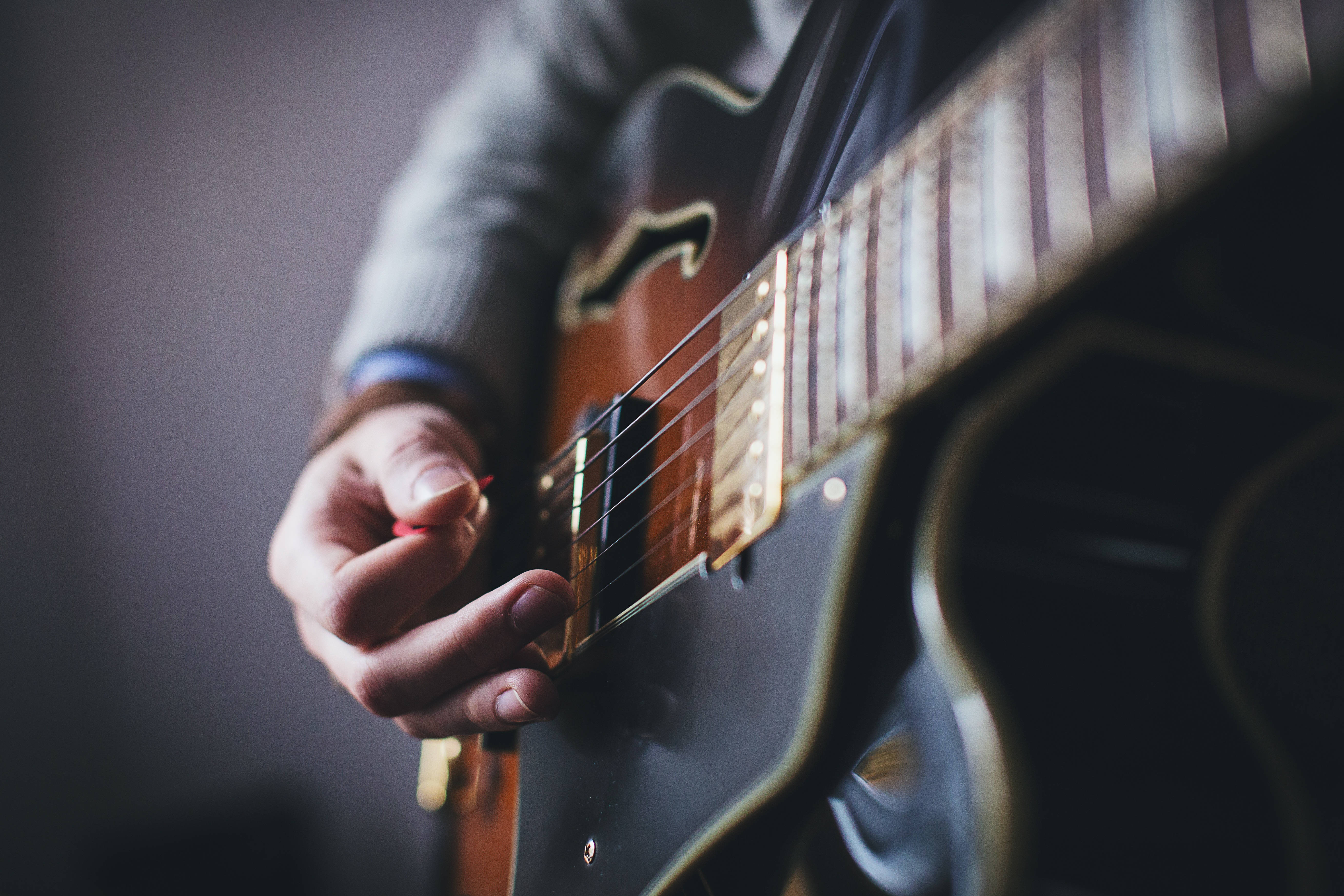sunburst electric guitar, hand plucking strings, close-up, 5K Desktop Wallpaper