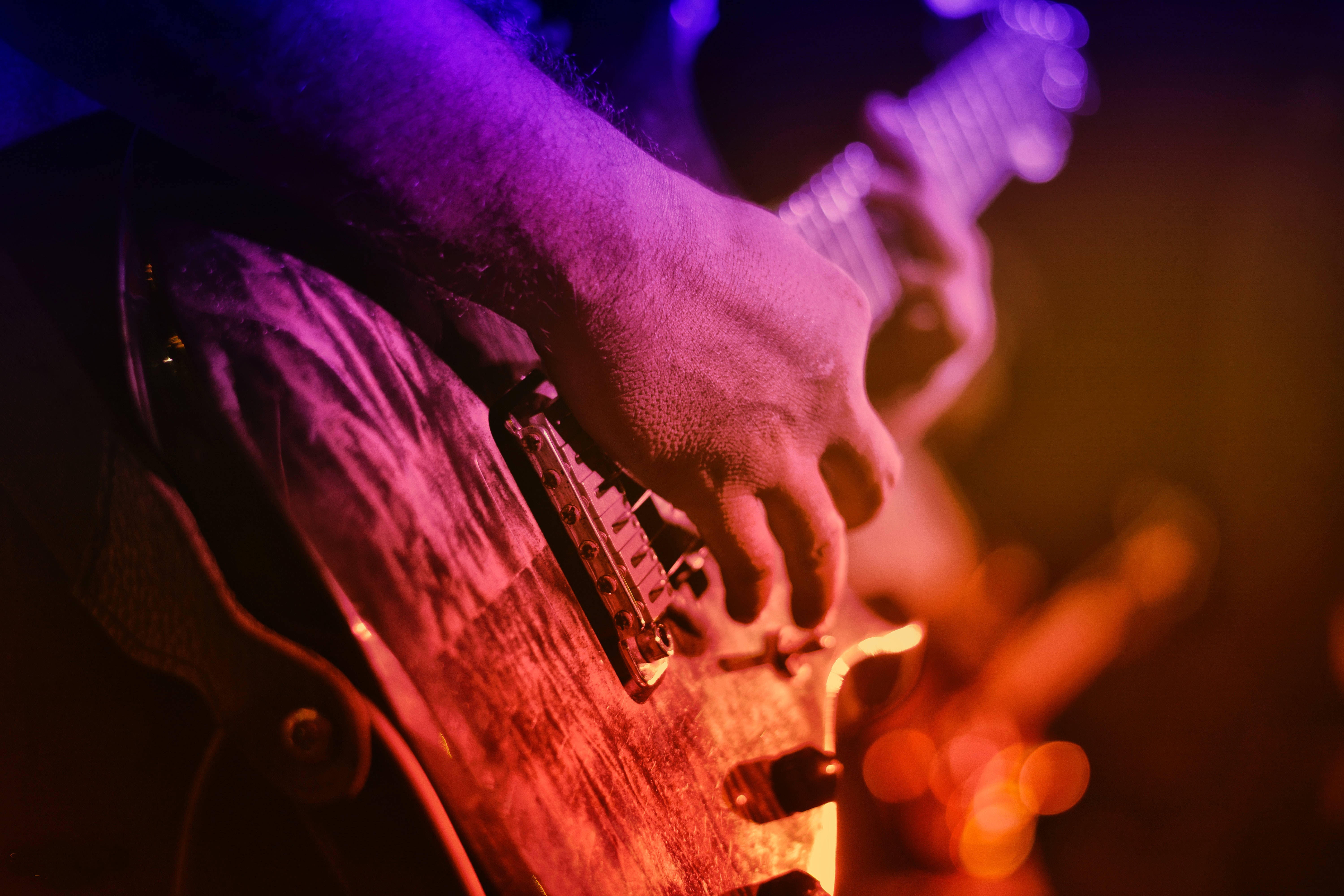 electric guitar, vibrant purple, orange stage lights, 5K Desktop Wallpaper