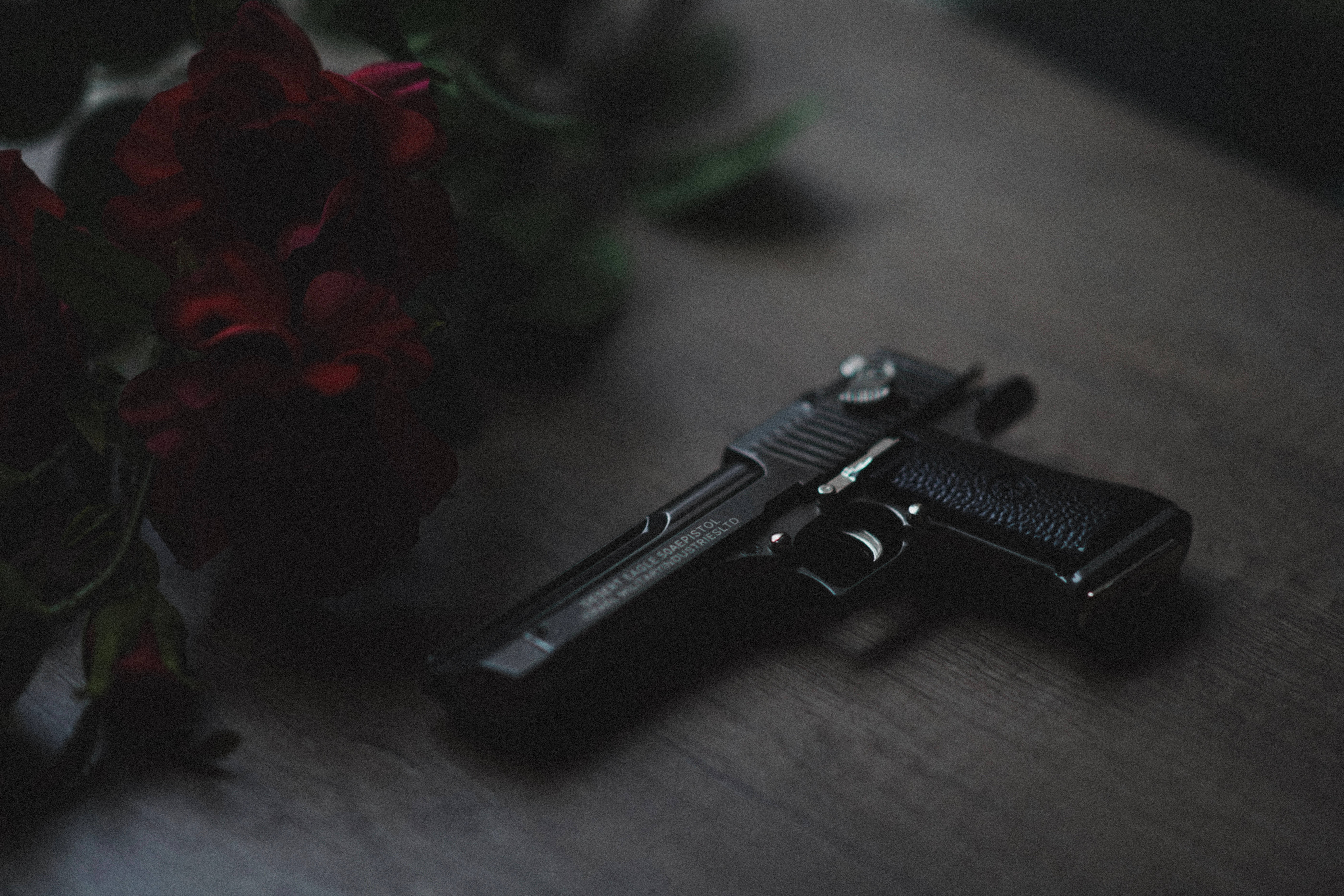 gun, red roses, black handgun, 8K Desktop Wallpaper