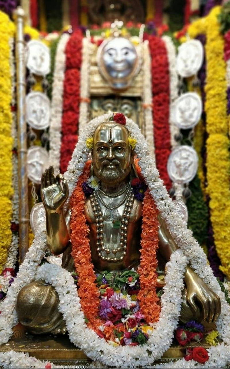 Guru Ji, golden deity statue, vibrant floral garlands, HD Phone Wallpaper