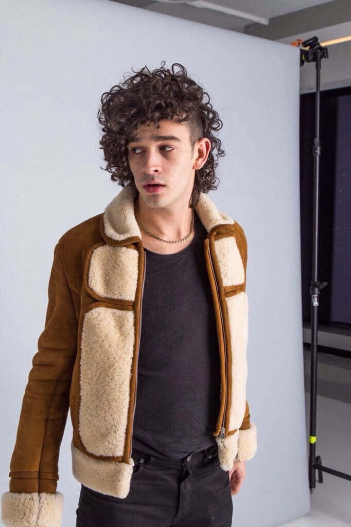 brown shearling jacket, curly hair, studio backdrop, SD Phone Wallpaper
