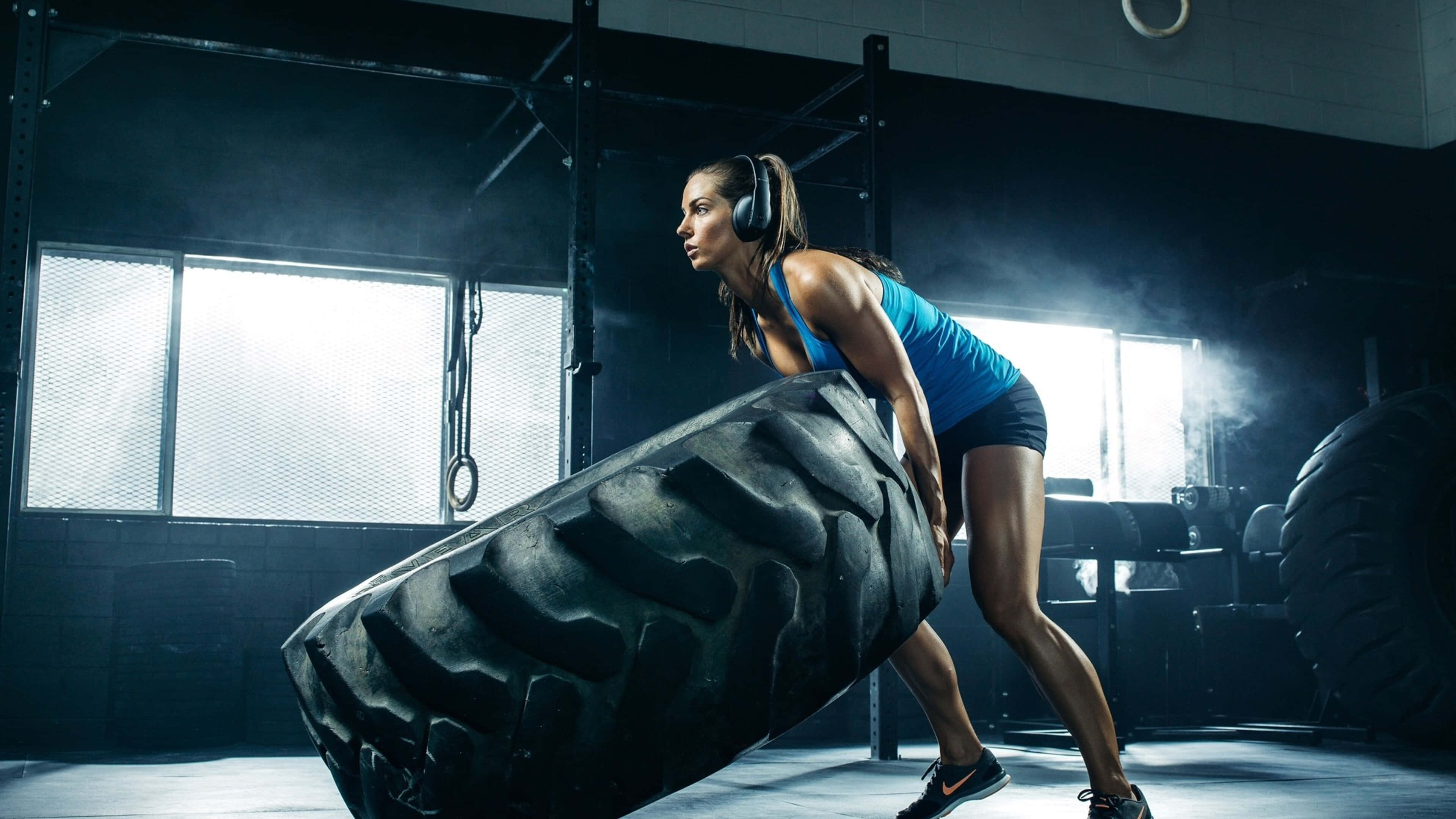 4K Gym, massive black tire, focused woman, 4K Desktop Wallpaper