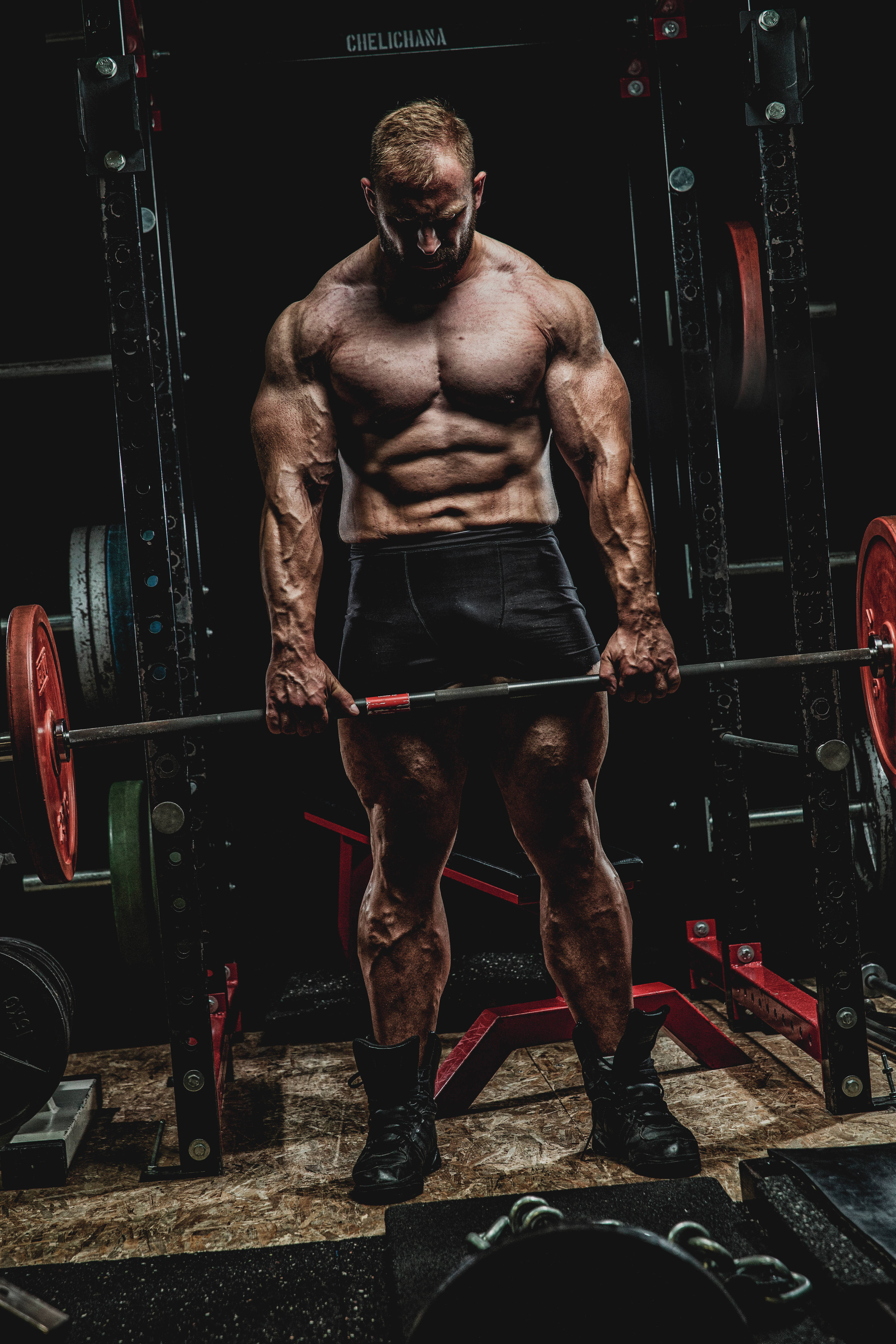 barbell, dimly lit gym, red weight plates, 5K Phone Wallpaper