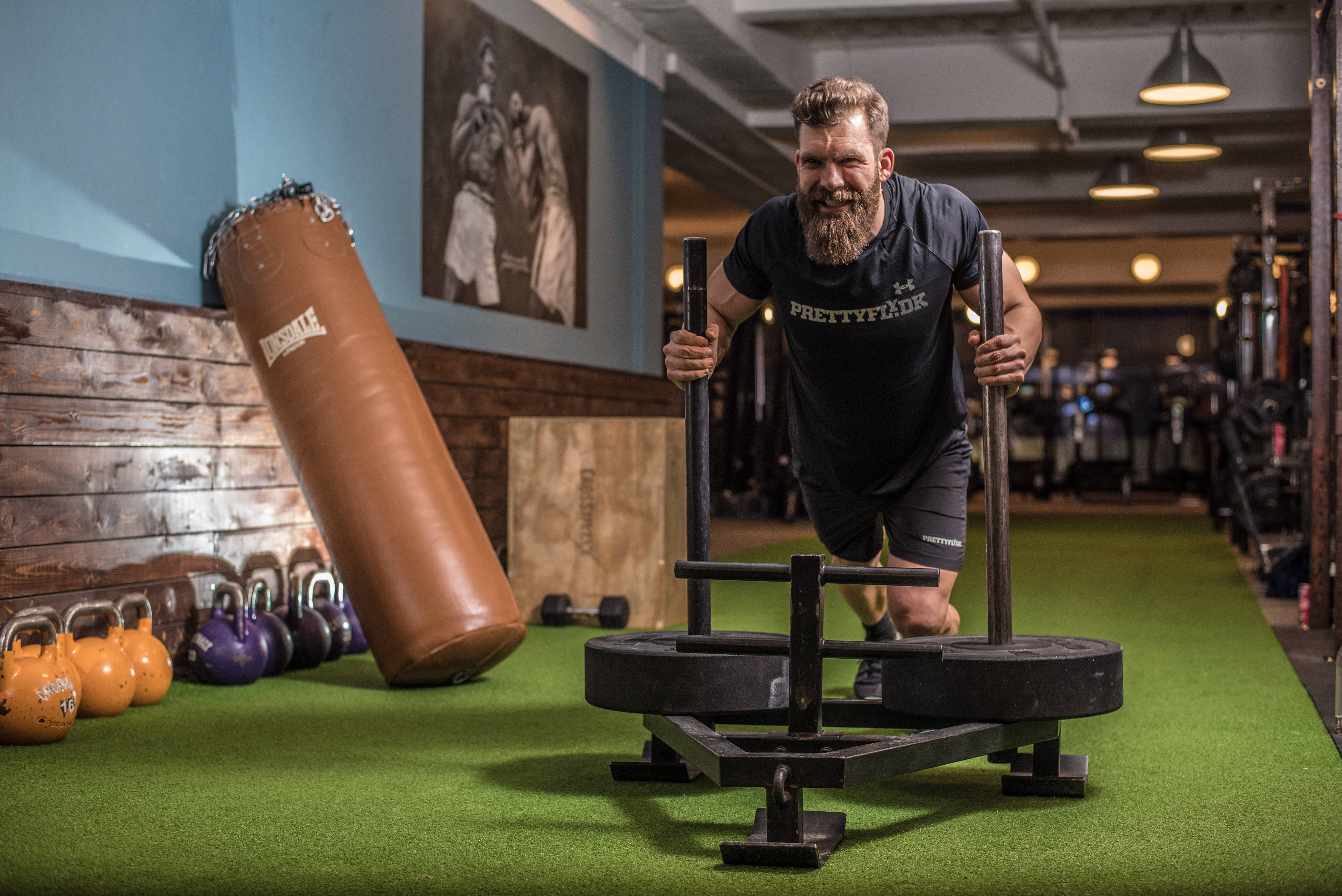 bearded man, weighted sled, green gym floor, 5K Desktop Wallpaper