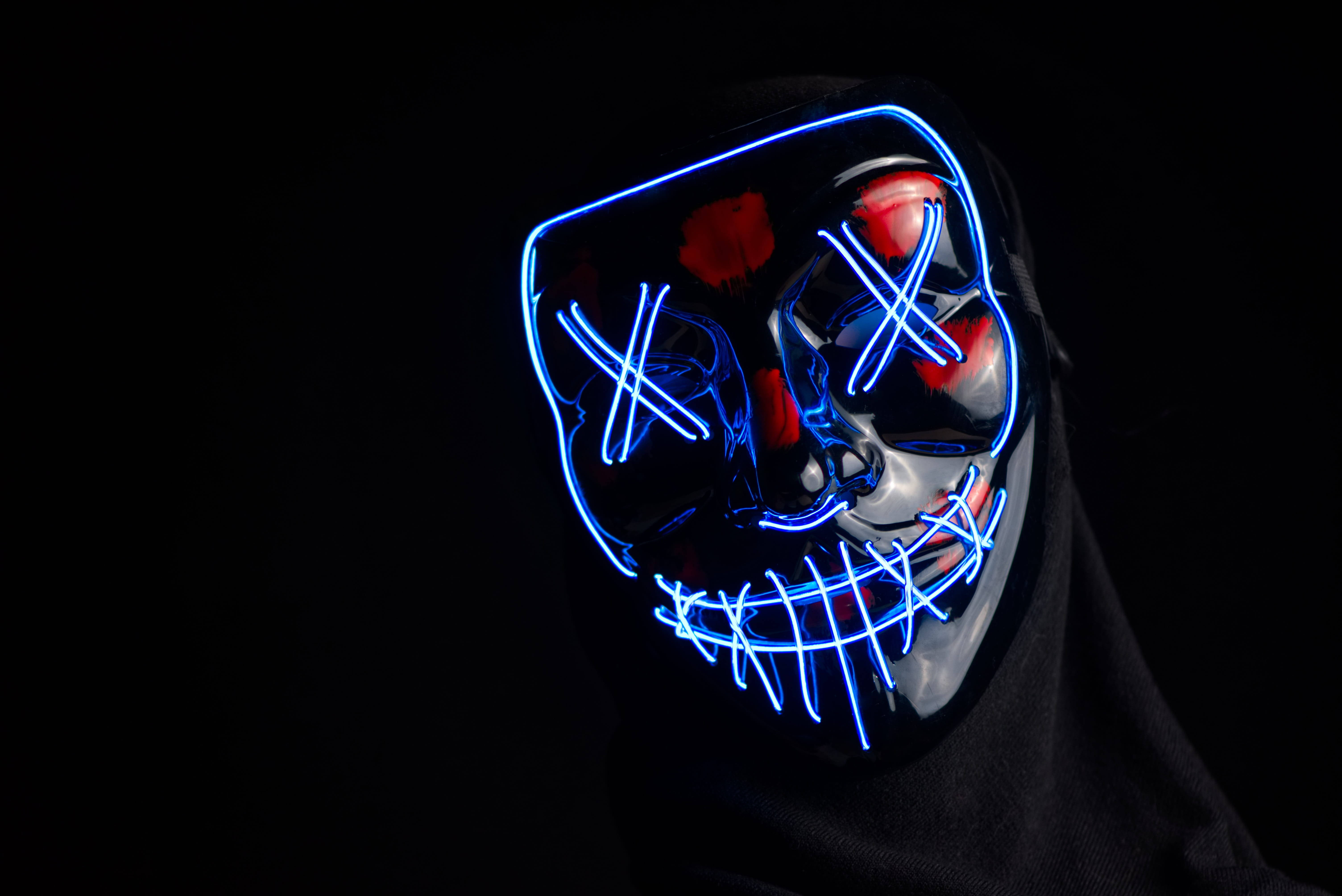 glowing blue LED mask, red eyes, stitched mouth, 5K Desktop Wallpaper