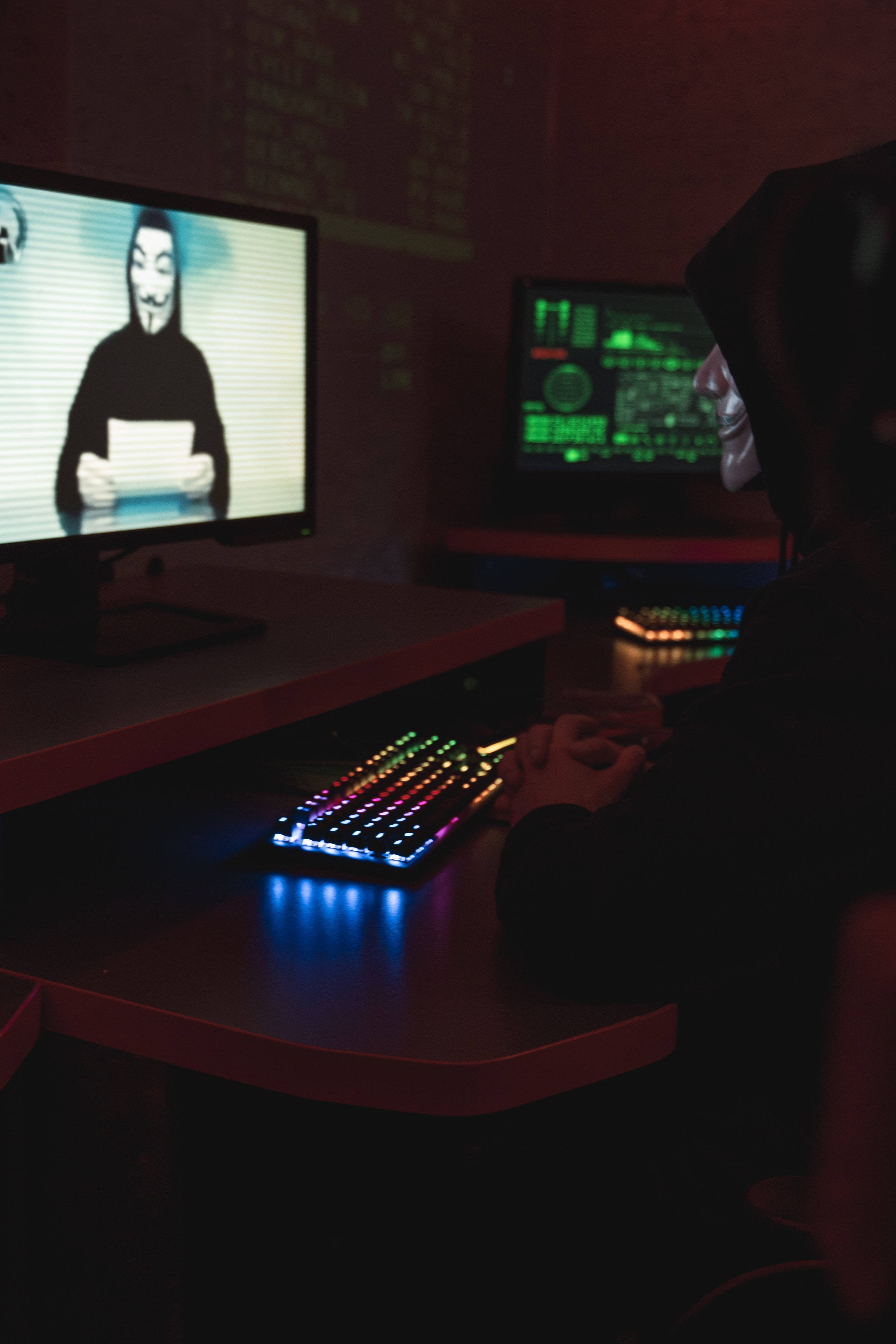 hacker mask, glowing keyboard, monitors displaying a masked person, 4K Phone Wallpaper