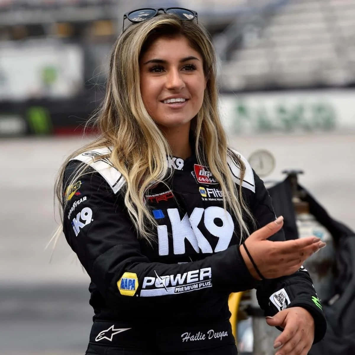 Hailie Deegan, black sponsor-covered racing suit, track, SD Desktop Wallpaper