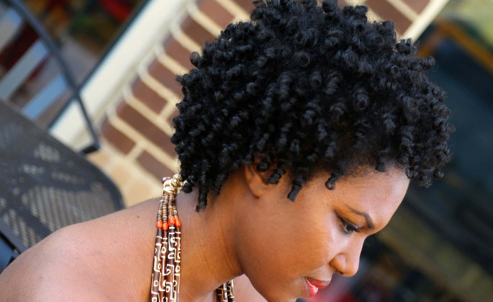voluminous black curly hair, beaded necklace, brick wall background, HD Desktop Wallpaper