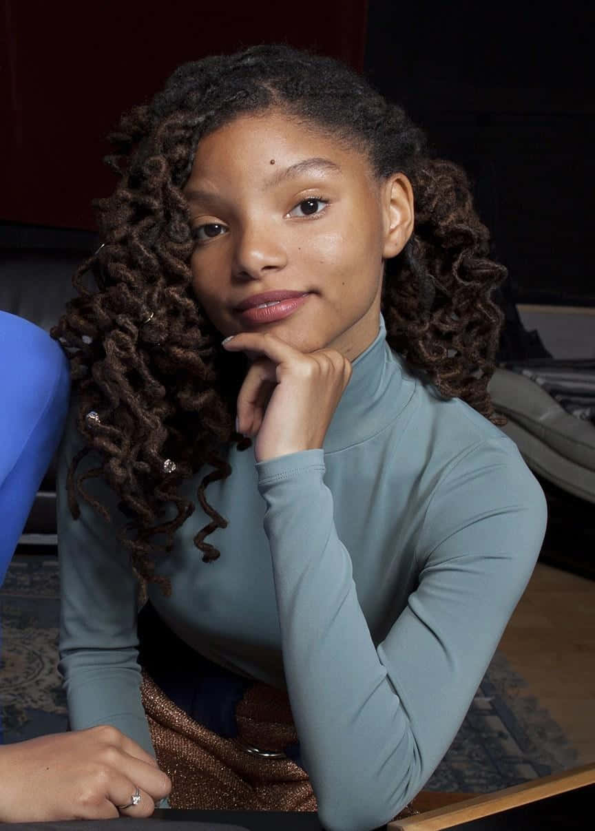 Halle Bailey, voluminous curly hair, chin on hand, SD Phone Wallpaper