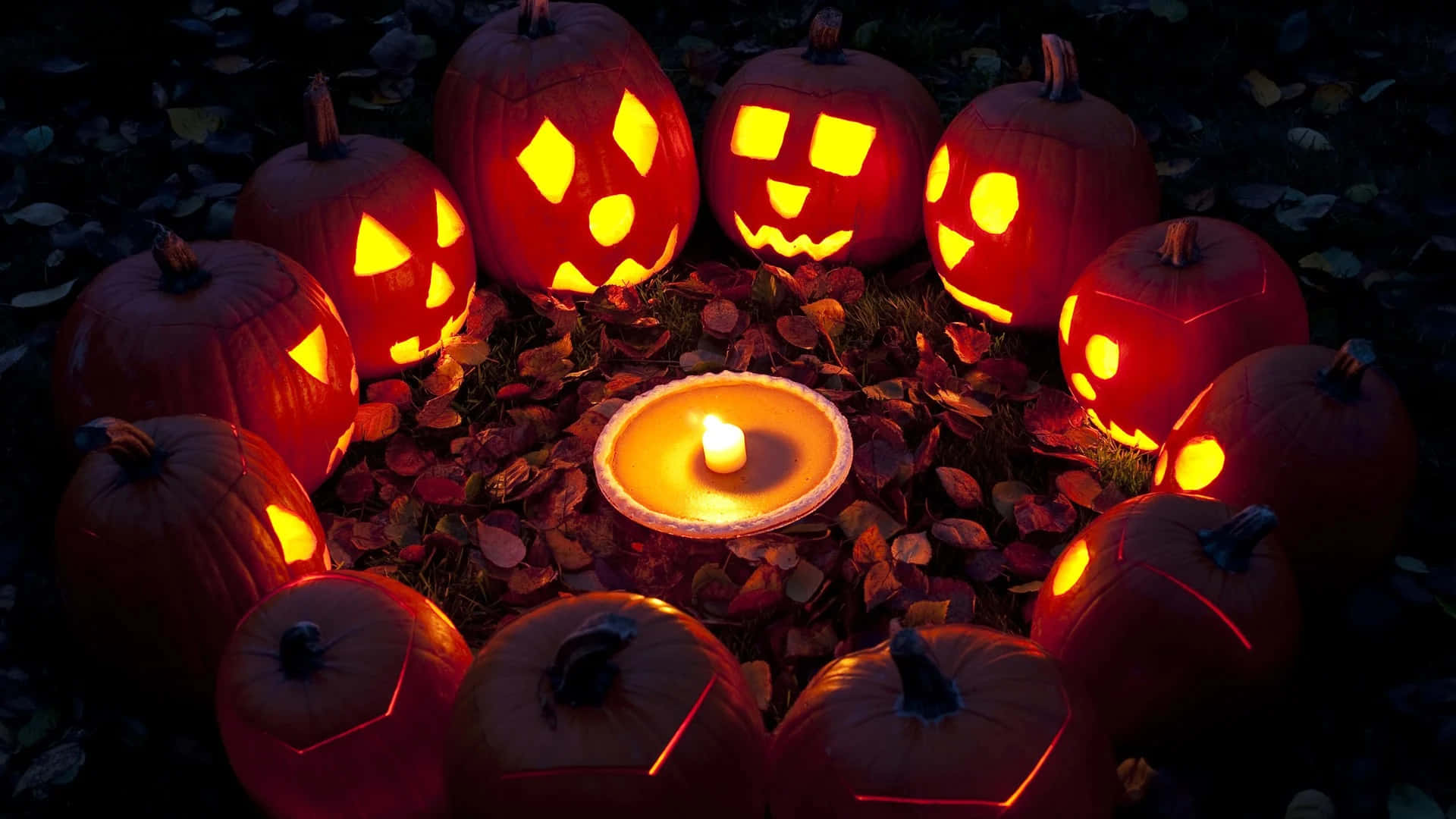 glowing jack-o'-lanterns, carved faces, lit candle, Full HD Desktop Wallpaper