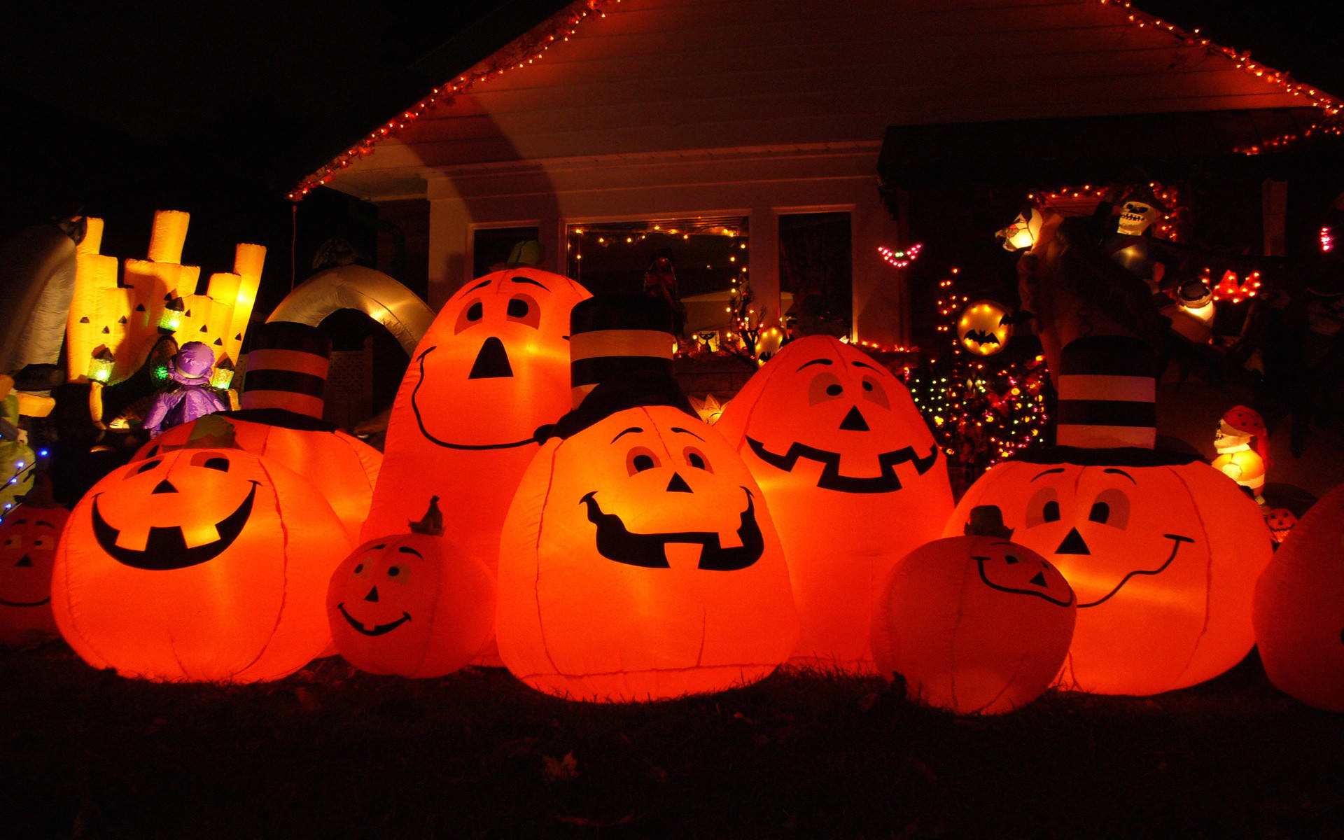 Glowing orange inflatable pumpkins, smiling faces, dark yard, Full HD Desktop Wallpaper