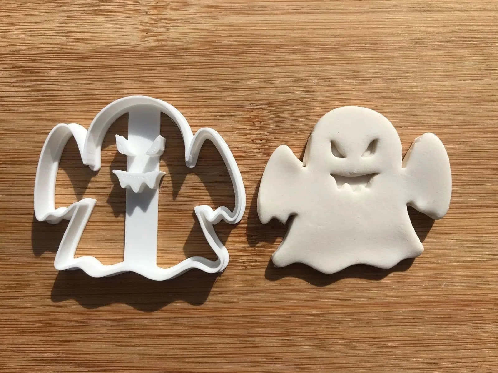 white ghost-shaped cookie cutter, matching cutout of dough, light brown wooden surface, HD Desktop Wallpaper