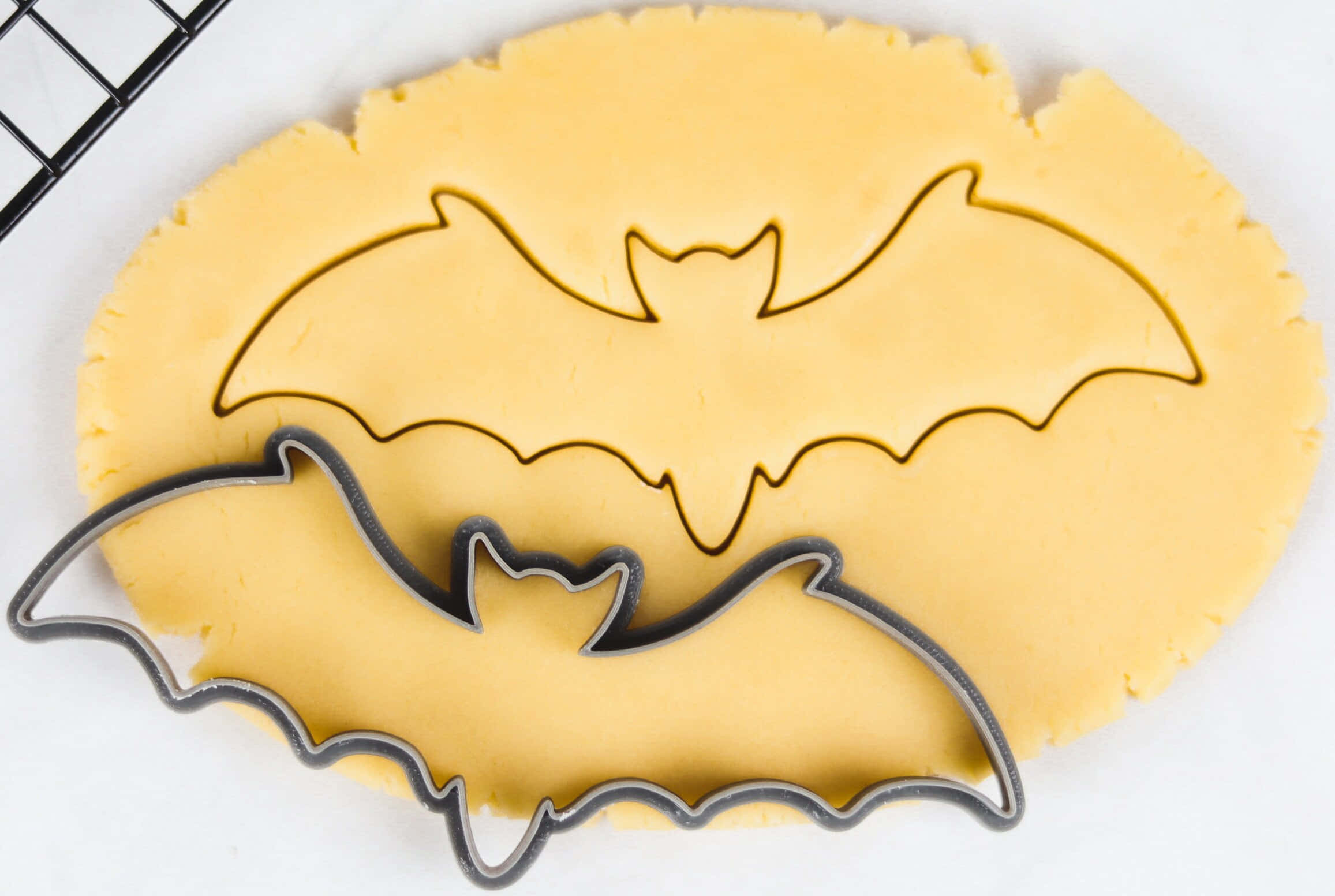bat-shaped cookie cutter, pale yellow dough, white surface, Full HD Desktop Wallpaper