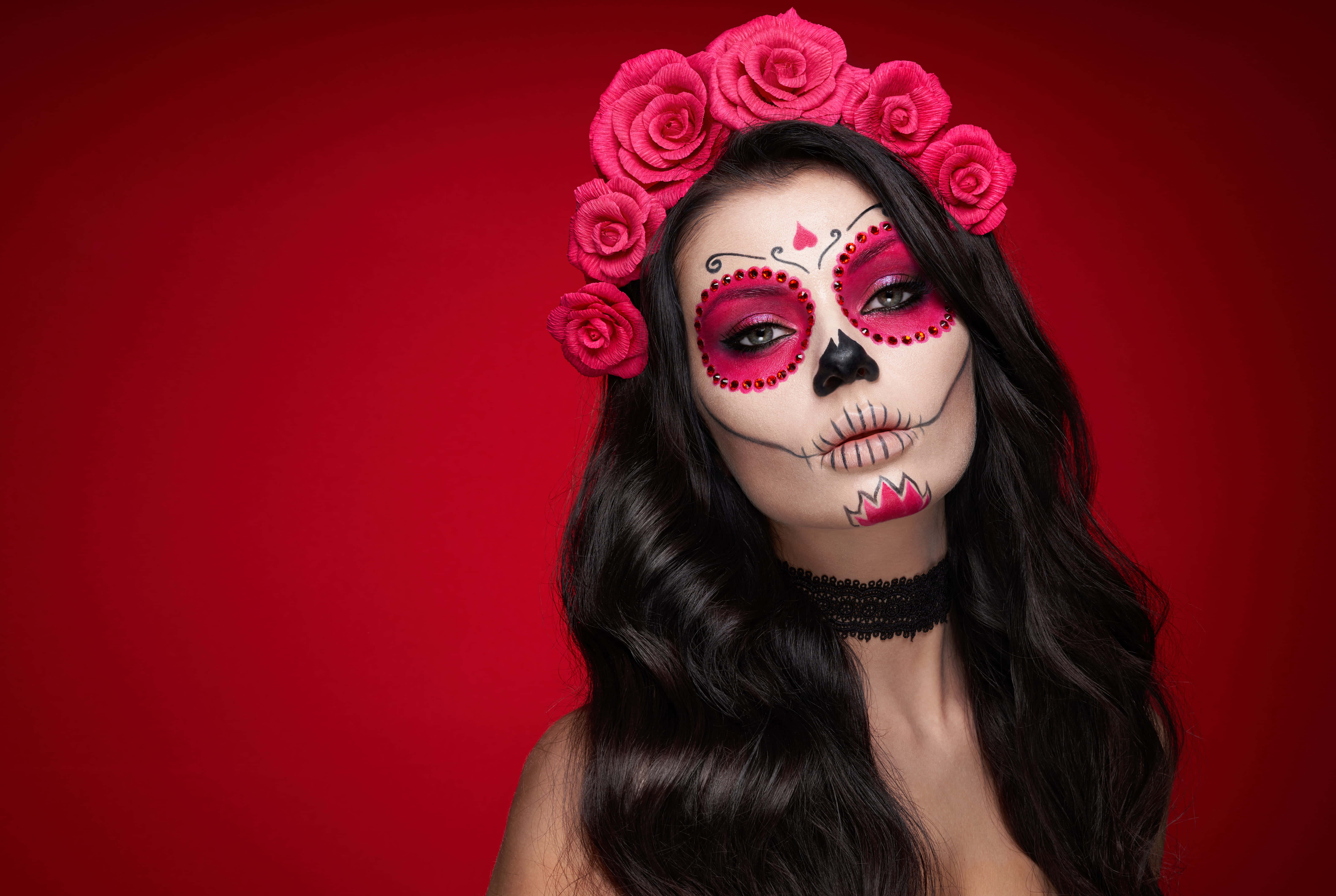 sugar skull makeup, pink rose crown, vivid red background, 5K Desktop Wallpaper