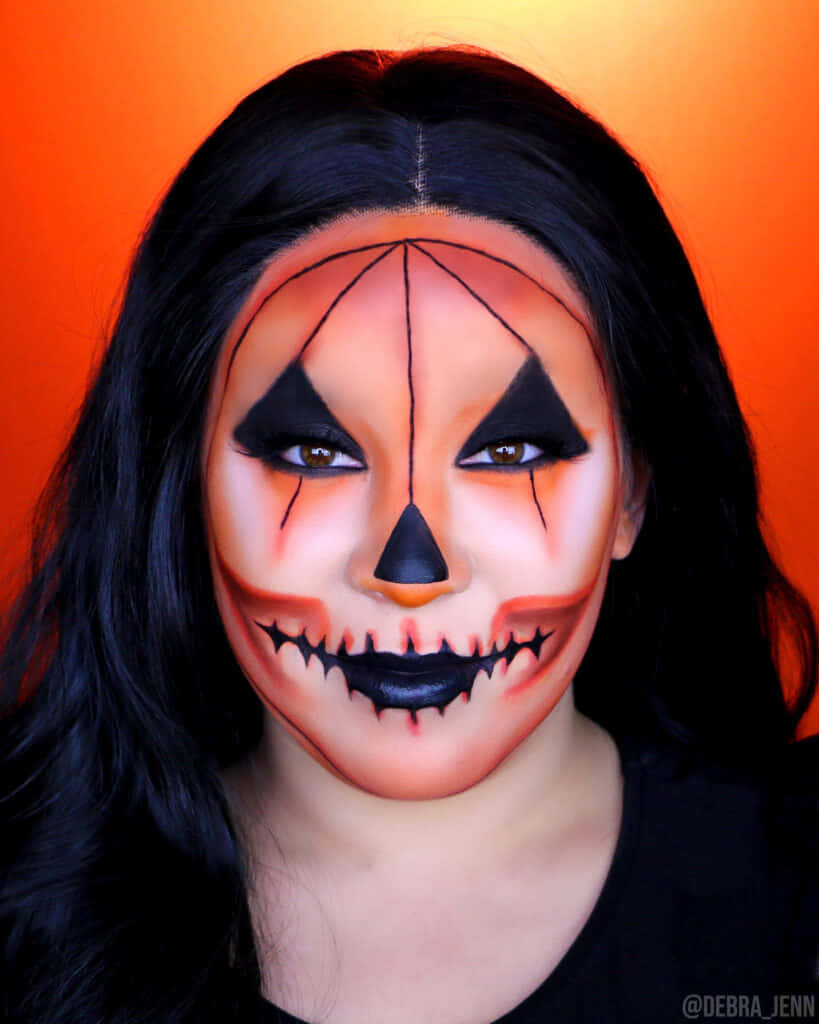 jack-o'-lantern face paint, vibrant orange background, dark hair, SD Phone Wallpaper